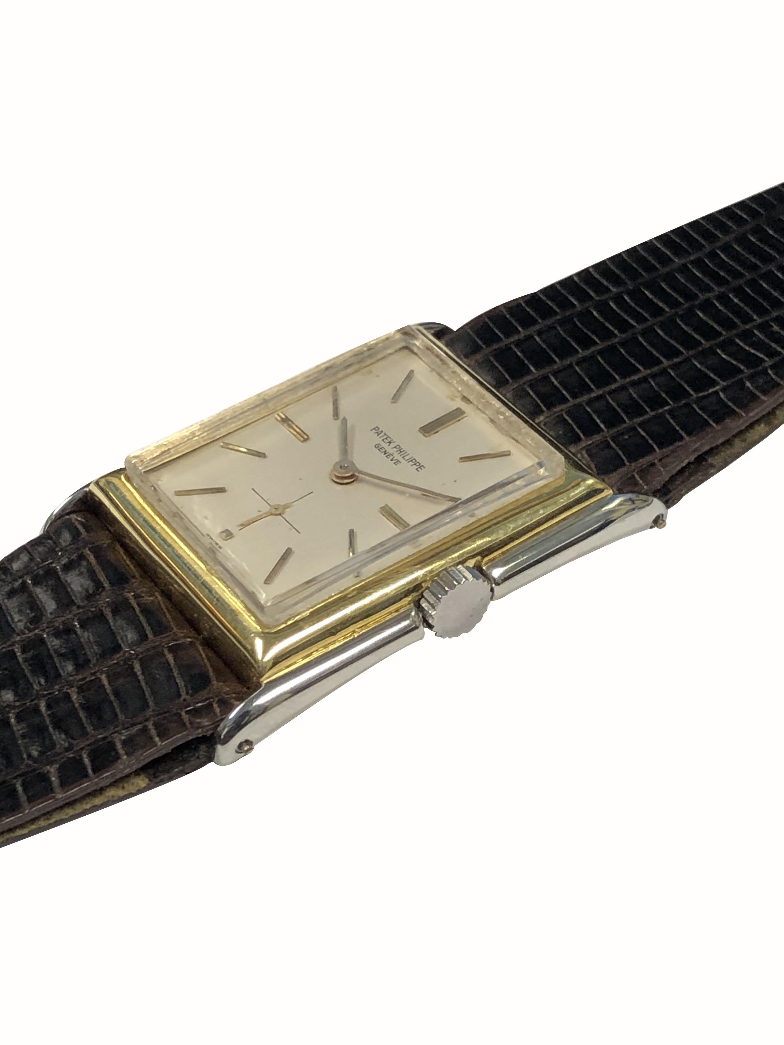 Circa 1920s Patek Philippe Wrist Watch,  39 M.M. Lug end to end X 29 M.M. 18K White and Yellow Gold 2 Piece Hinged Stepped case with slight Flared Lugs. Mechanical, manual wind 18 Jewel Nickle Lever movement. Silver Satin dial with raised Gold