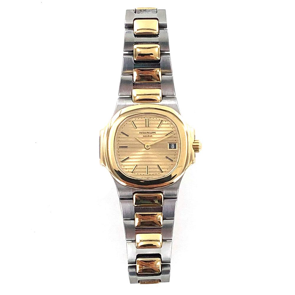 1990's Patek Philippe Nautilus watch is fashioned in 18 karat yellow gold and stainless steel. The Nautilus is known for its rounded octagonal shape bezel, and horizontally ribbed dial. The watch also features 27mm case, sapphire crystal, deployment