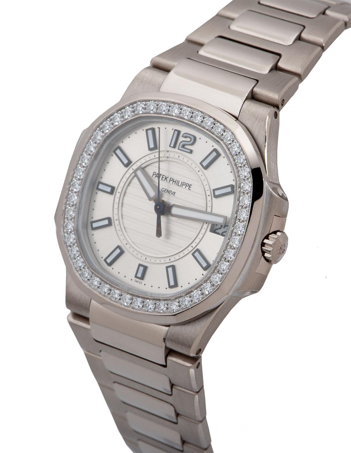 A 34 mm 18k White Gold Nautilus Ladies Wristwatch, silver dial with applied hour markers and applied arabic number 12, date at 3 0'clock, a fixed 18k white gold bezel set with 46 round brilliant cut diamonds (~0.77ct), an 18k white gold bracelet
