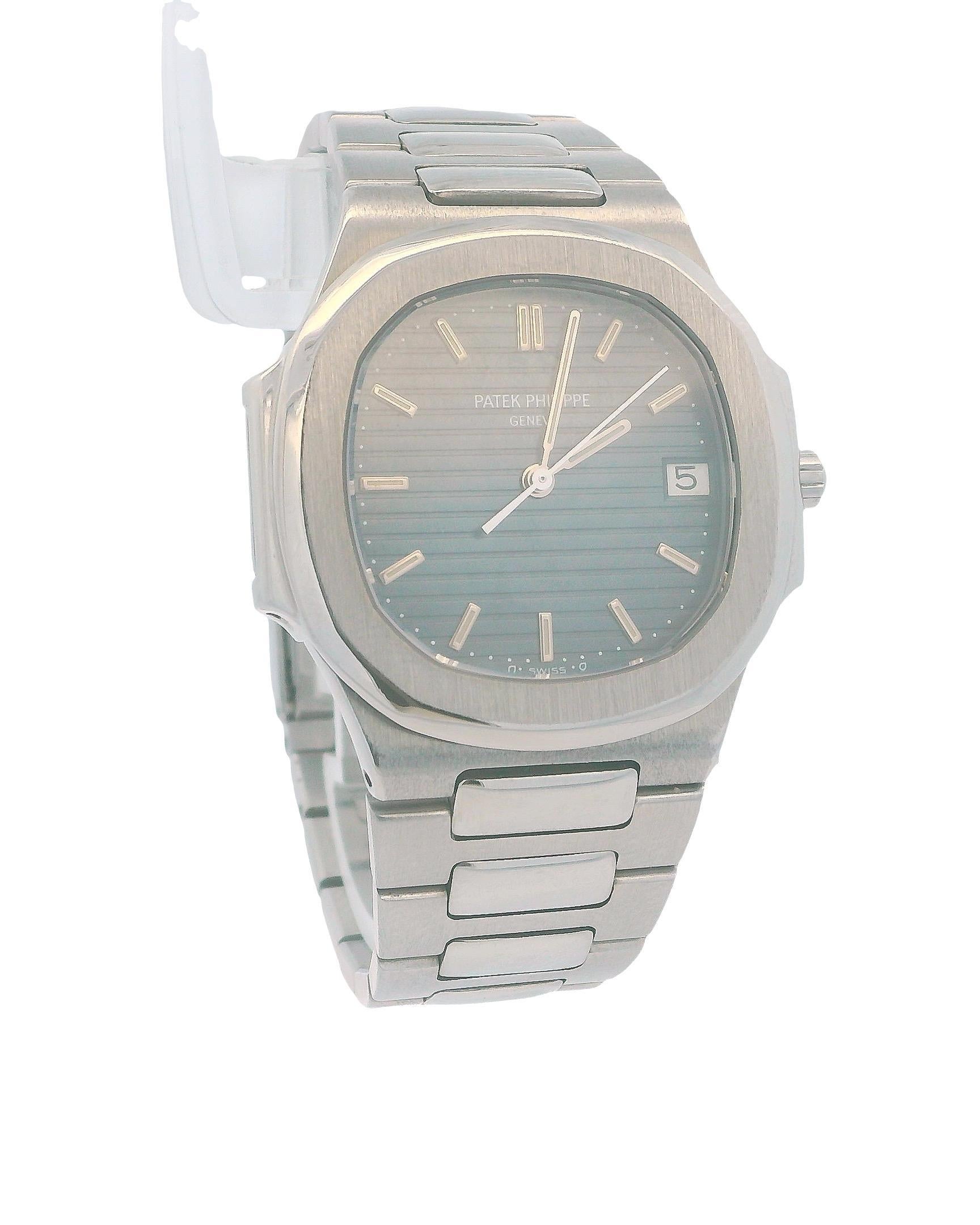 Patek Philippe Nautilus 3900/1A Ladies Watch. This timepiece features a 32mm stainless steel case with a smooth stainless steel bezel. The blue dial is complemented by stainless steel hands and index hour markers. The date is displayed at the 3