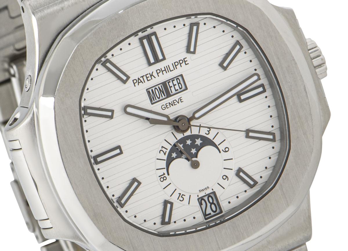 An extremely sought after Patek Philippe Nautilus, in stainless featuring the discontinued silvery white dial which displays the day, date, month and features a moon phase display with a 24-hour indicator. Complementing the dial is a stainless steel