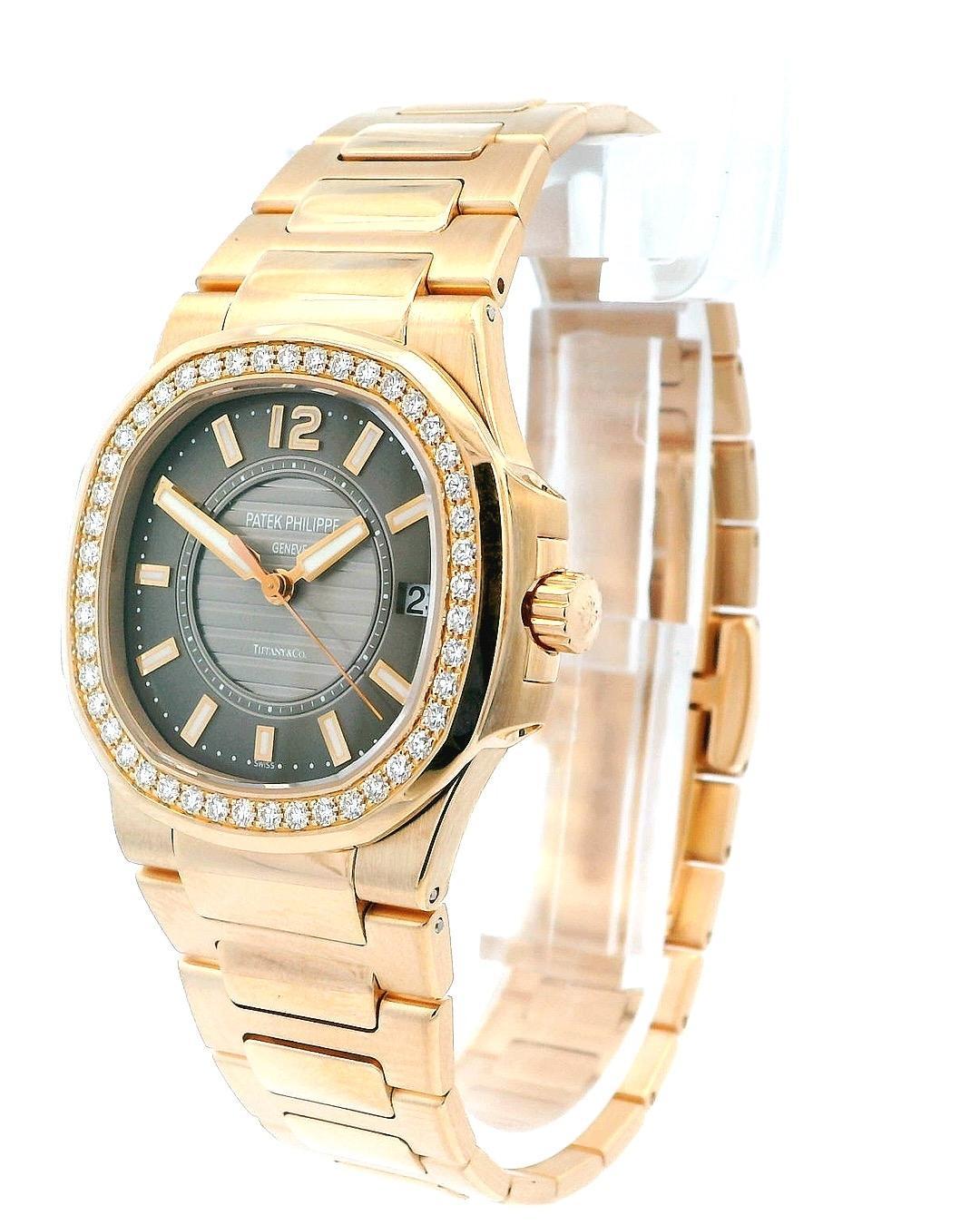 Patek Philippe Nautilus 7010/1R Ladies Watch. 32mm 18K rose gold case and factory diamond bezel. Tiffany & Co taupe dial with luminous rose gold hands and index hour markers. The date is displayed at 3 o'clock. Rose gold bracelet with hidden