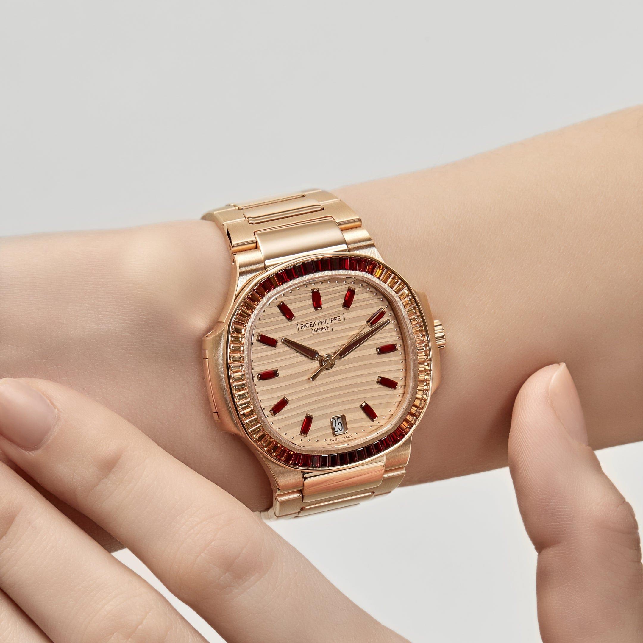 Introducing the Patek Philippe Ladies Nautilus 7118/1300R-001, a stunning jewelry rendition that seamlessly blends rose gold with the captivating allure of spessartite garnet gemstones. Its octagonal bezel features a striking row of 68 gems,
