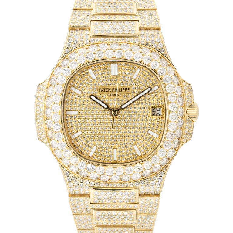 Brand: Patek Philippe
Model: Nautilus
Case Material: 18k Yellow Gold
Case Diameter: 40mm
Crystal: Scratch resistant sapphire
Bezel: All aftermarker Diamond 18k Yellow gold bezel
Dial: All aftermarker Diamond dial
Bracelet: All aftermarket Diamond