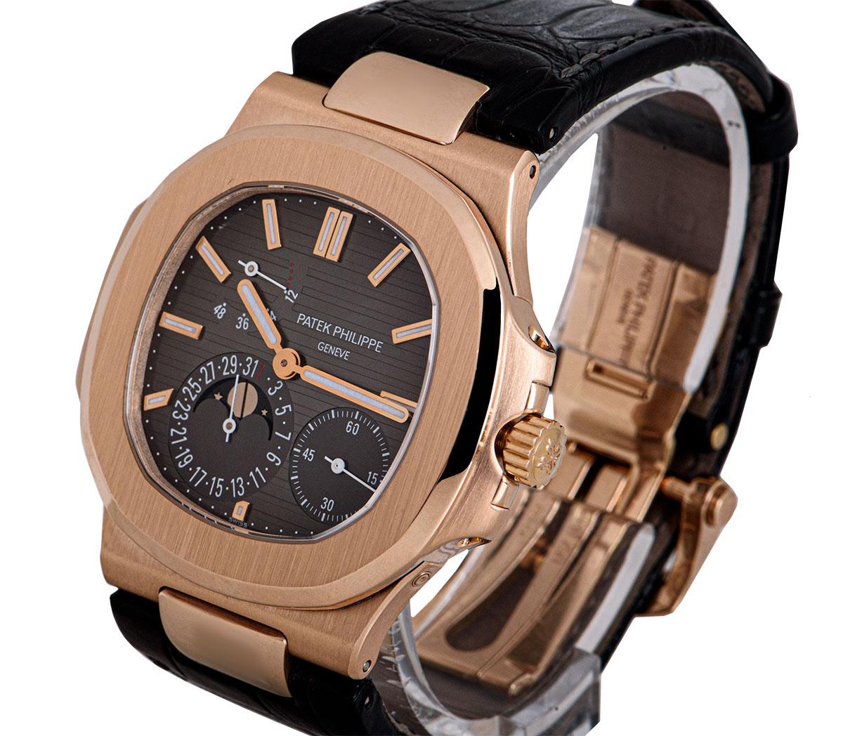 A 40 mm 18k Rose Gold Nautilus Gents Wristwatch, black brown dial with applied hour markers, small seconds between 3 and 6 0'clock, date with moonphase display at 7 0'clock, power reserve indicator between 9 and 12 0'clock, a fixed 18k rose gold