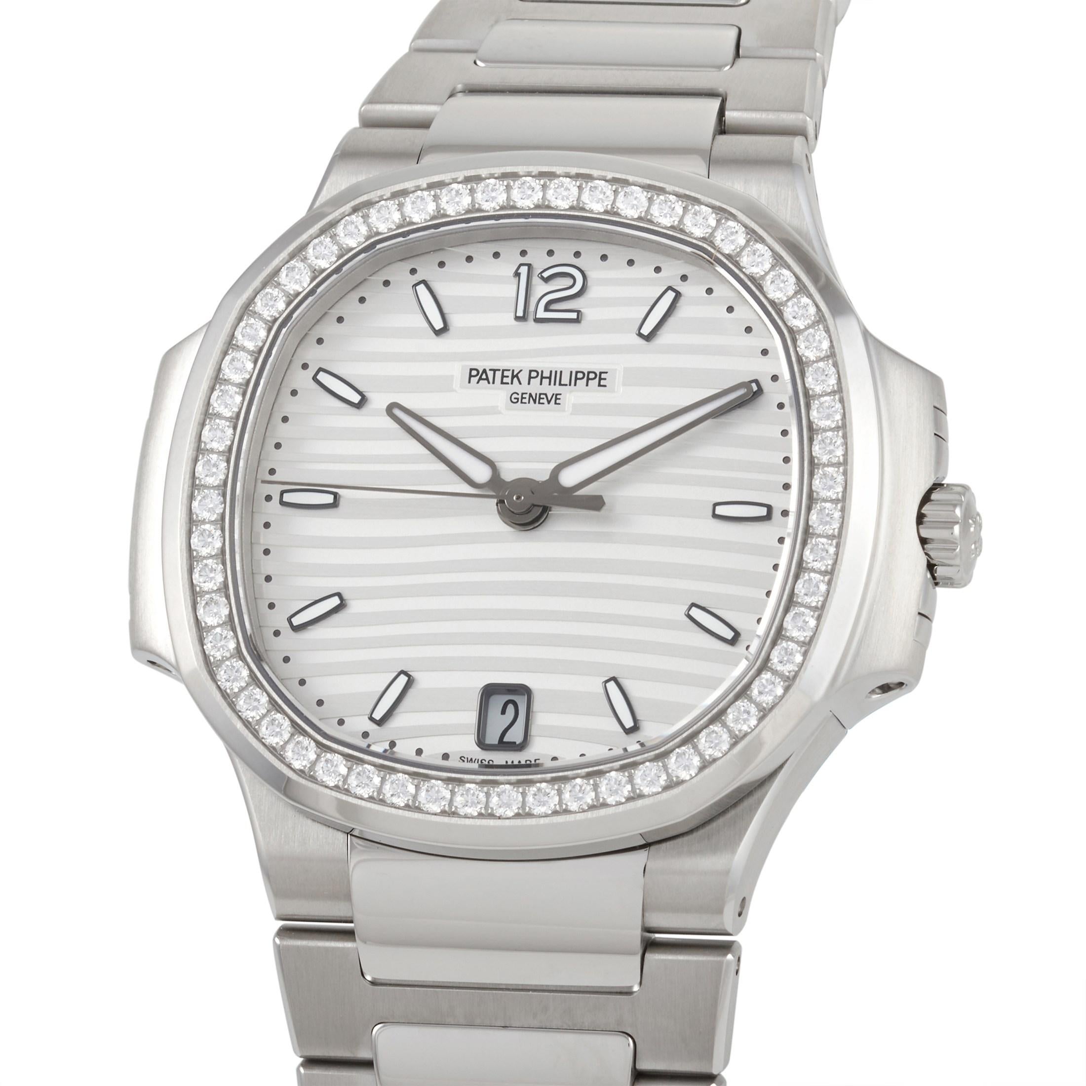 The striking presence of the Patek Philippe Ladies Automatic Nautilus Watch 7118/1200A-010 cannot be denied. This Nautilus model sports a slightly larger 35.2 mm stainless steel case. It features a silvery opaline dial with gold applied hour markers