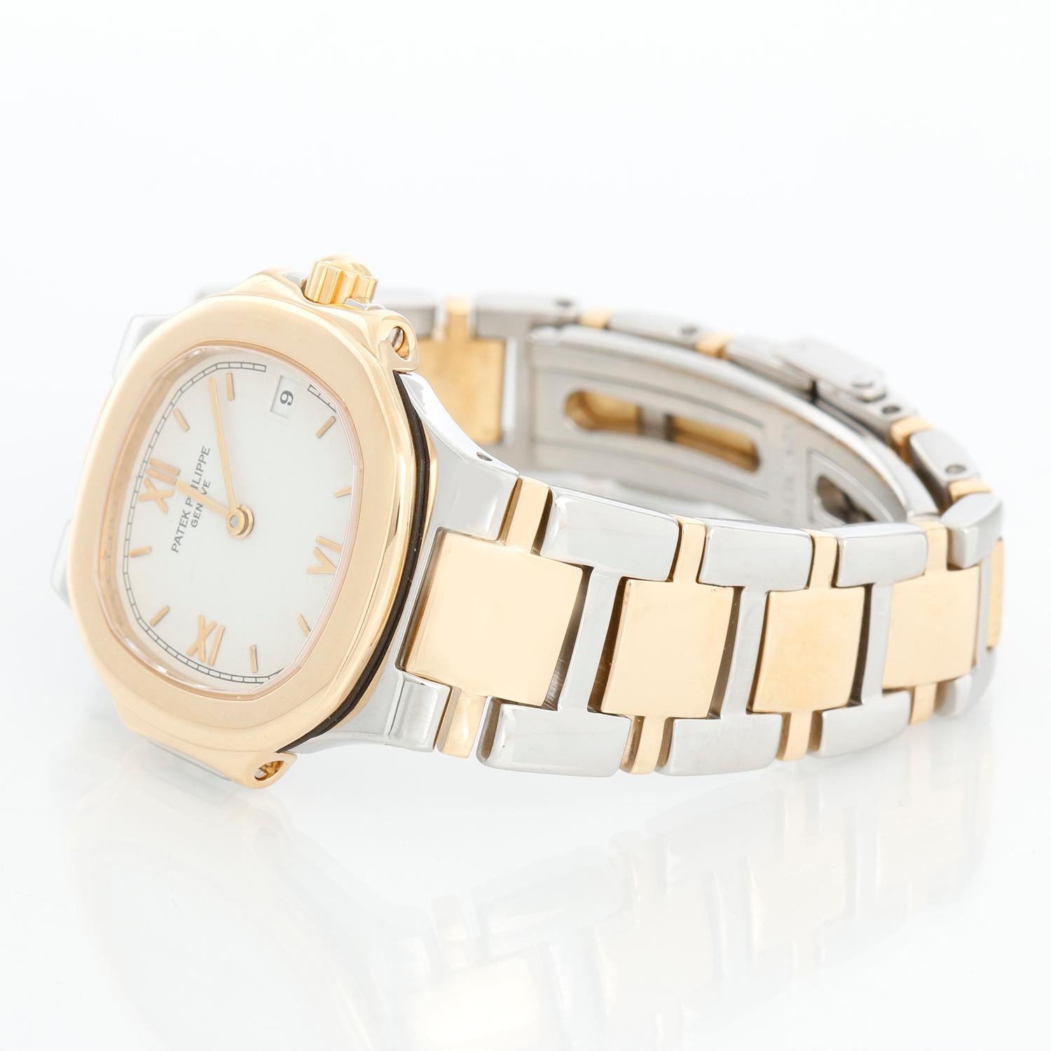Patek Philippe Nautilus Ladies Steel Gold 2-Tone  Watch  4700/61 - Quartz. Stainless steel case with 18k yellow gold bezel (26mm diameter). White  dial with stick markers; date at 3 o'clock position. Stainless steel and 18k yellow gold Nautilus