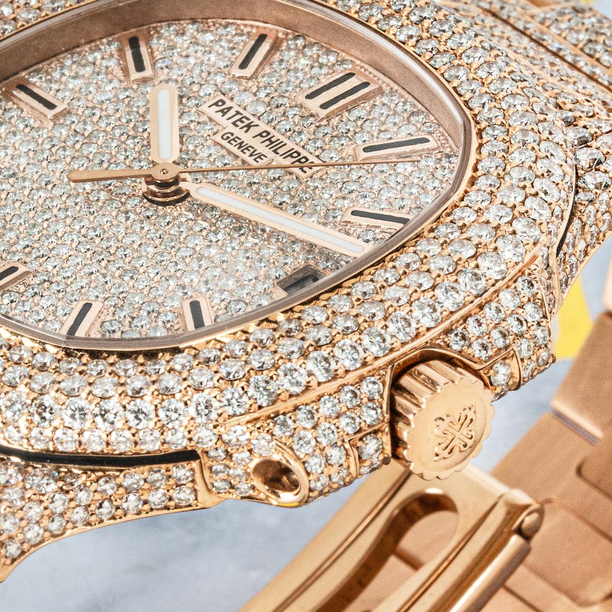 The Patek Philippe Nautilus 5711/1R-001 in 18k Rose Gold is an iconic luxury sports watch, now enhanced with an aftermarket custom diamond setting. It features a scratch-resistant sapphire crystal and a self-winding automatic movement, visible