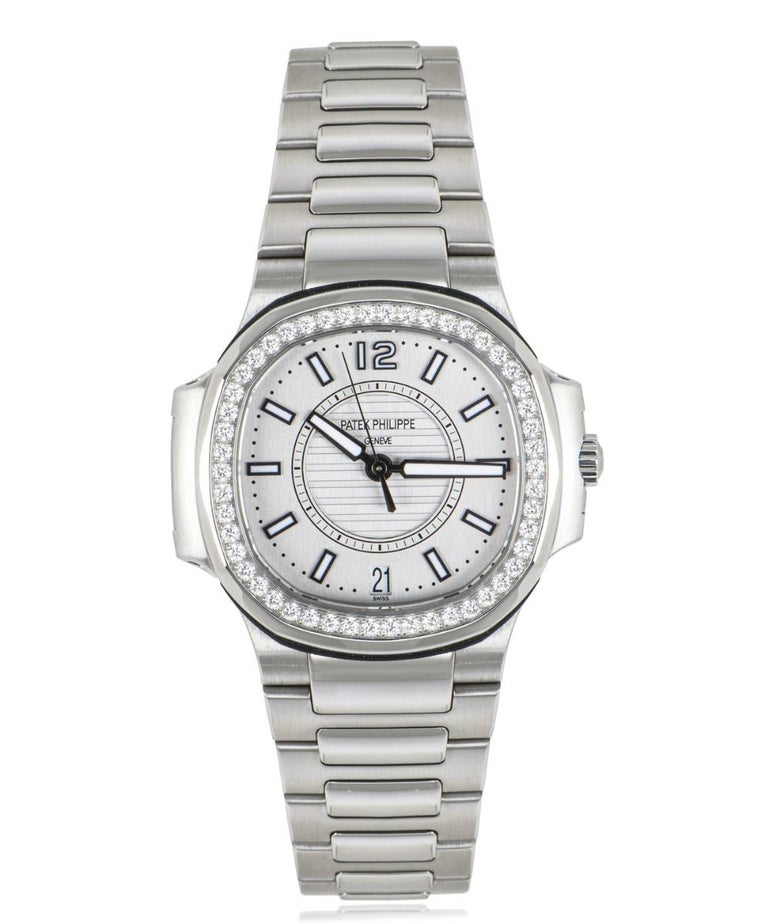 A stainless steel 32mm women's Nautilus by Patek Philippe. Featuring a gray dial with a date aperture. Complementing the dial is a sapphire crystal and a fixed diamond set bezel. There are approximately 50 round brilliant cut diamonds, with a total