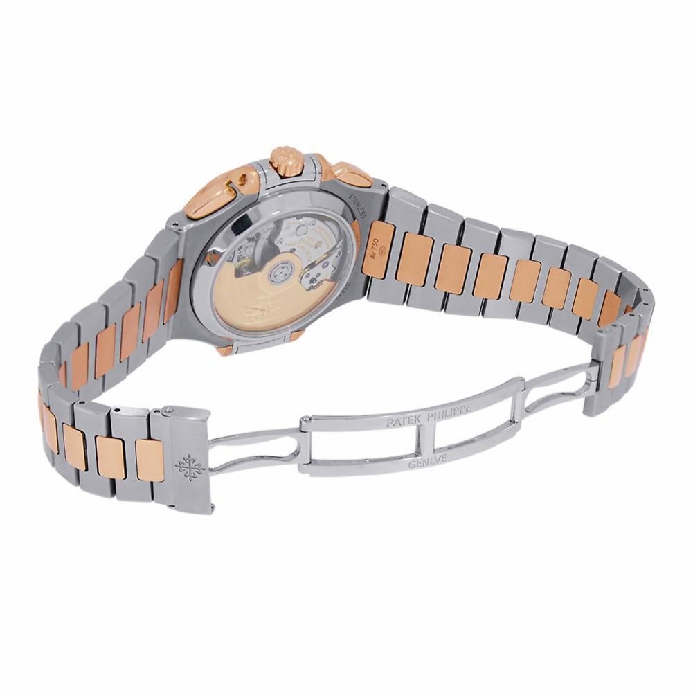 Patek Philippe Nautilus Reference #:5980/1AR. 18Kt rose gold case with a stainless steel and 18kt rose gold bracelet. Fixed rose gold bezel. Blue gradient dial with rose gold-tone hands and index hour markers. Minute markers around the outer rim.