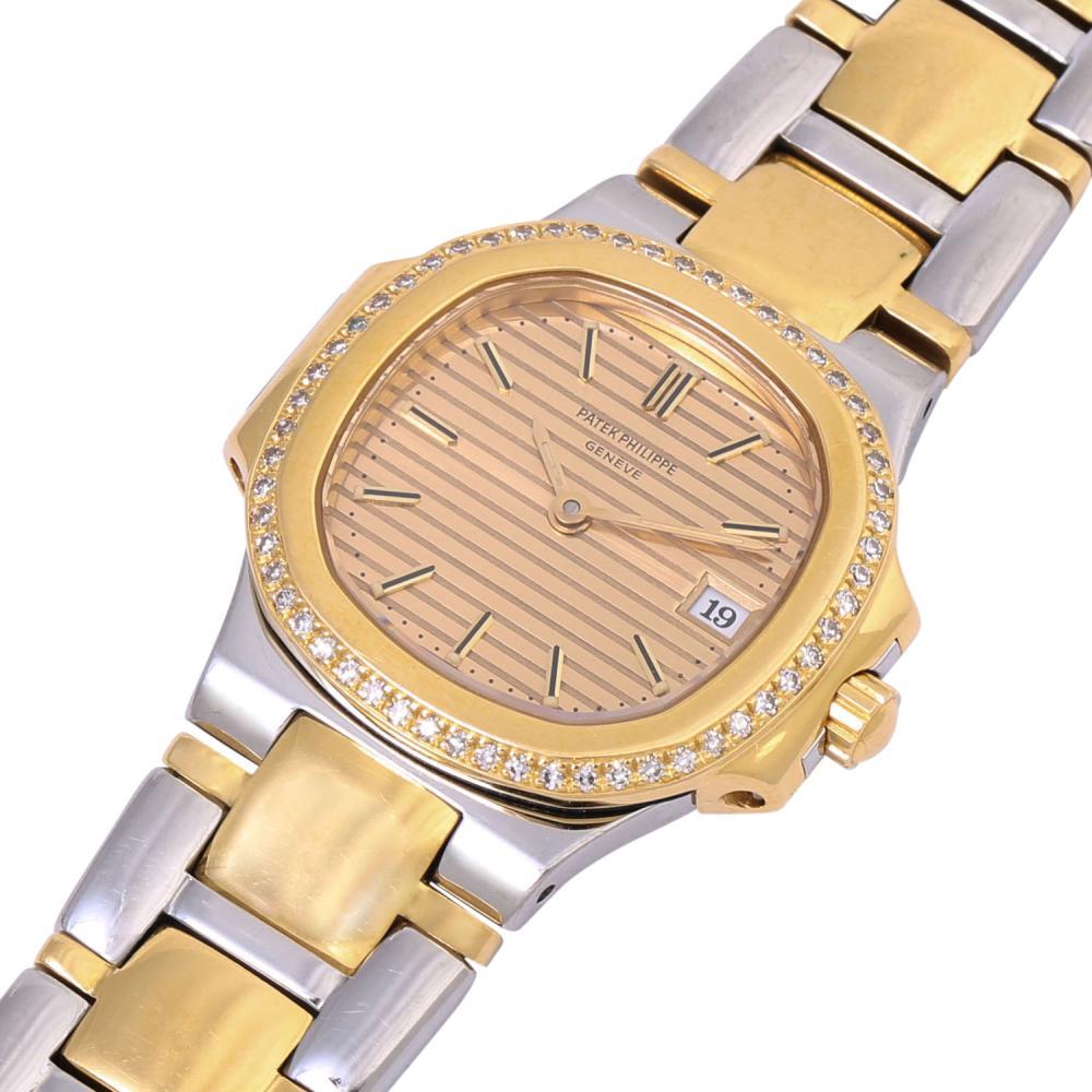 PATEK PHILIPPE Nautilus Vintage Lady steel/yellow gold 18k with factory diamonds. 
Ladies' wrist watch, ref. 4700/52. Stainless steel/yellow gold 18K, case number 2876844, bezel set with 56 diamonds (factory). Quartz
movement cal. E19C with new