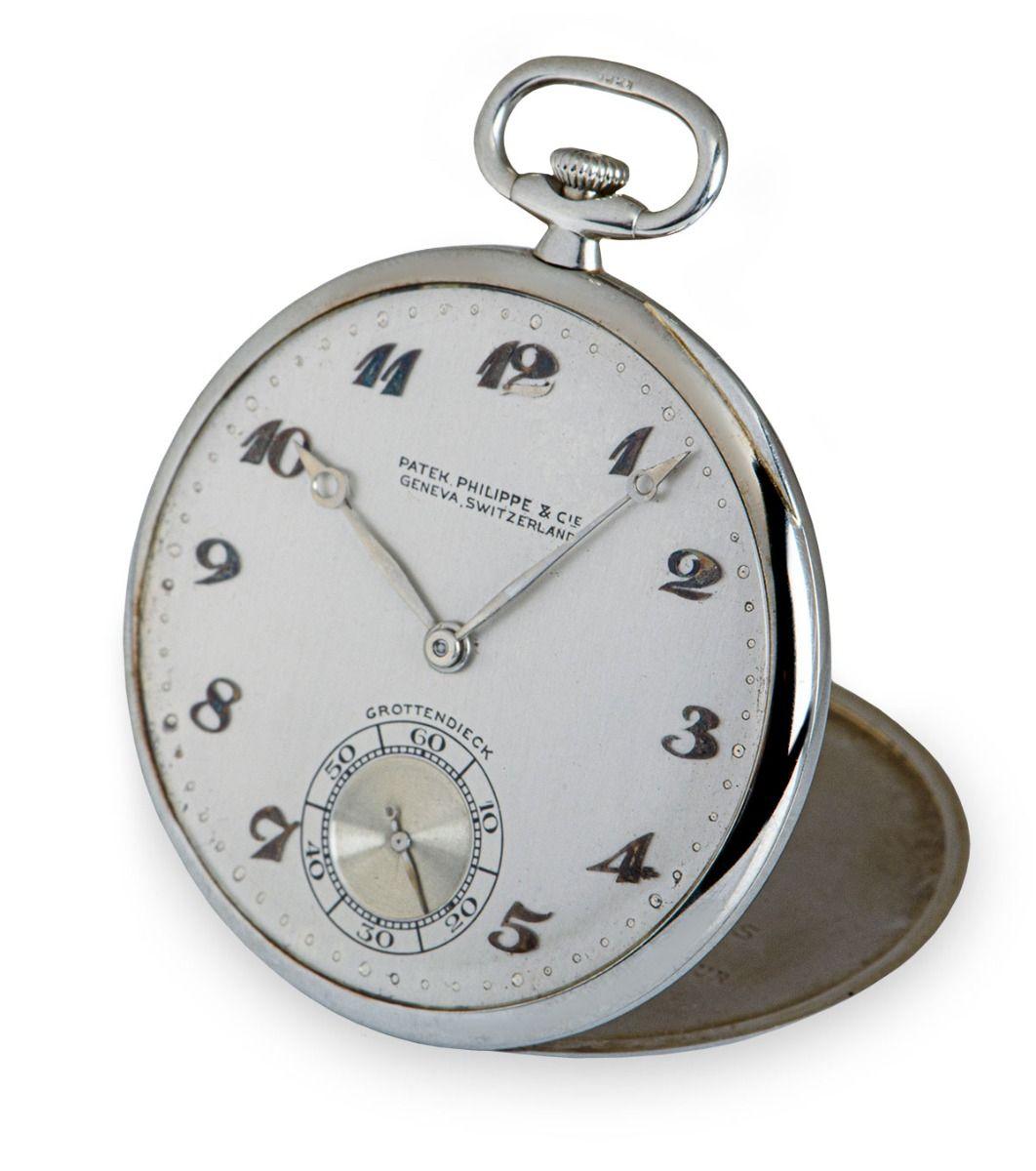 An Open Faced 43 mm Bassine Style Double Name Grottendieck men's pocket watch, by Patek Philippe.

The 18k white gold timpiece features a silvered dial with Breguet style numerals and small seconds display, plastic glass and a manual wind