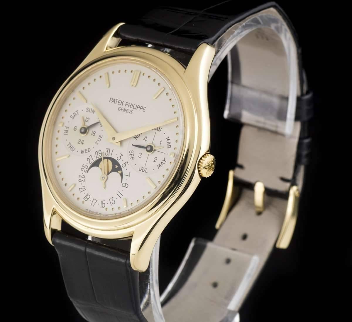 An 18k Yellow Gold Perpetual Calendar Gents Wristwatch, silver dial with applied hour markers, month and leap year indicator at 3 0'clock, date and moonphase aperture at 6 0'clock, weekday and am/pm indicator at 9 0'clock, a fixed 18k yellow gold