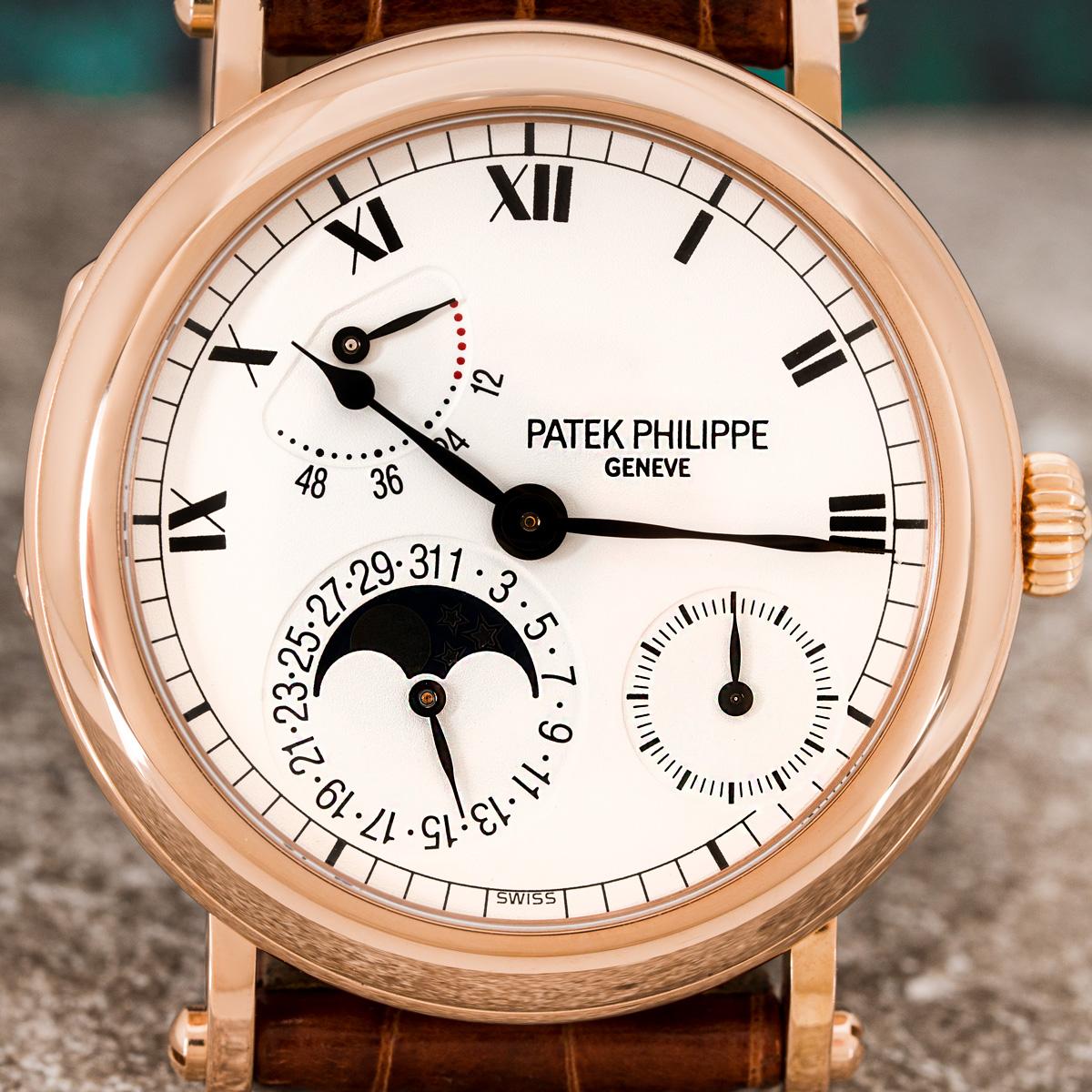 A rose gold power reserve moonphase wristwatch by Patek Philippe. Features a white dial with roman numerals, 2 sub-dials featuring a small second and date as well as a moonphase indicator and power reserve.

Fitted with a sapphire glass and a