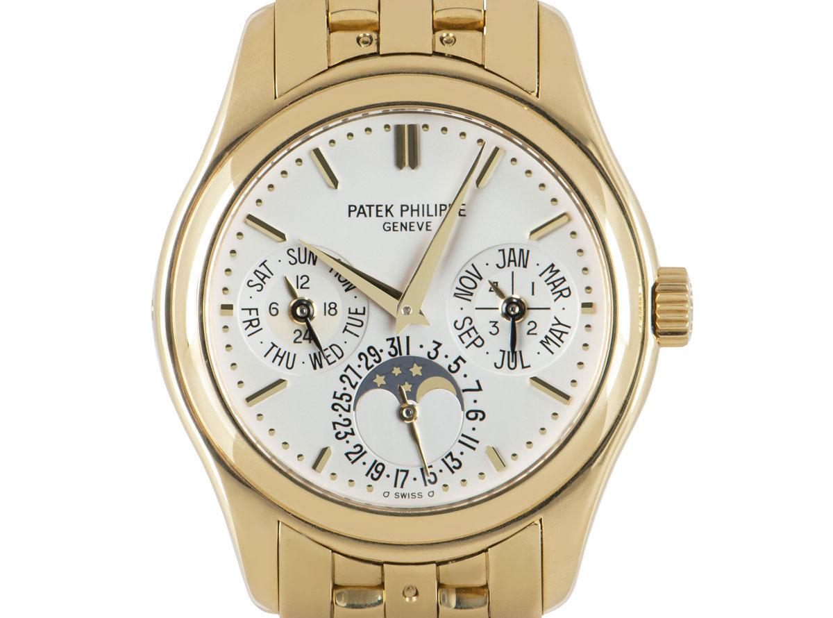 A rare 37 mm Grand Complications Perpetual Calendar in yellow gold by Patek Philippe. Its silver dial concealed with sapphire glass features moon phases with a date display, a day and 24 hour display and a month and leap year display. The original