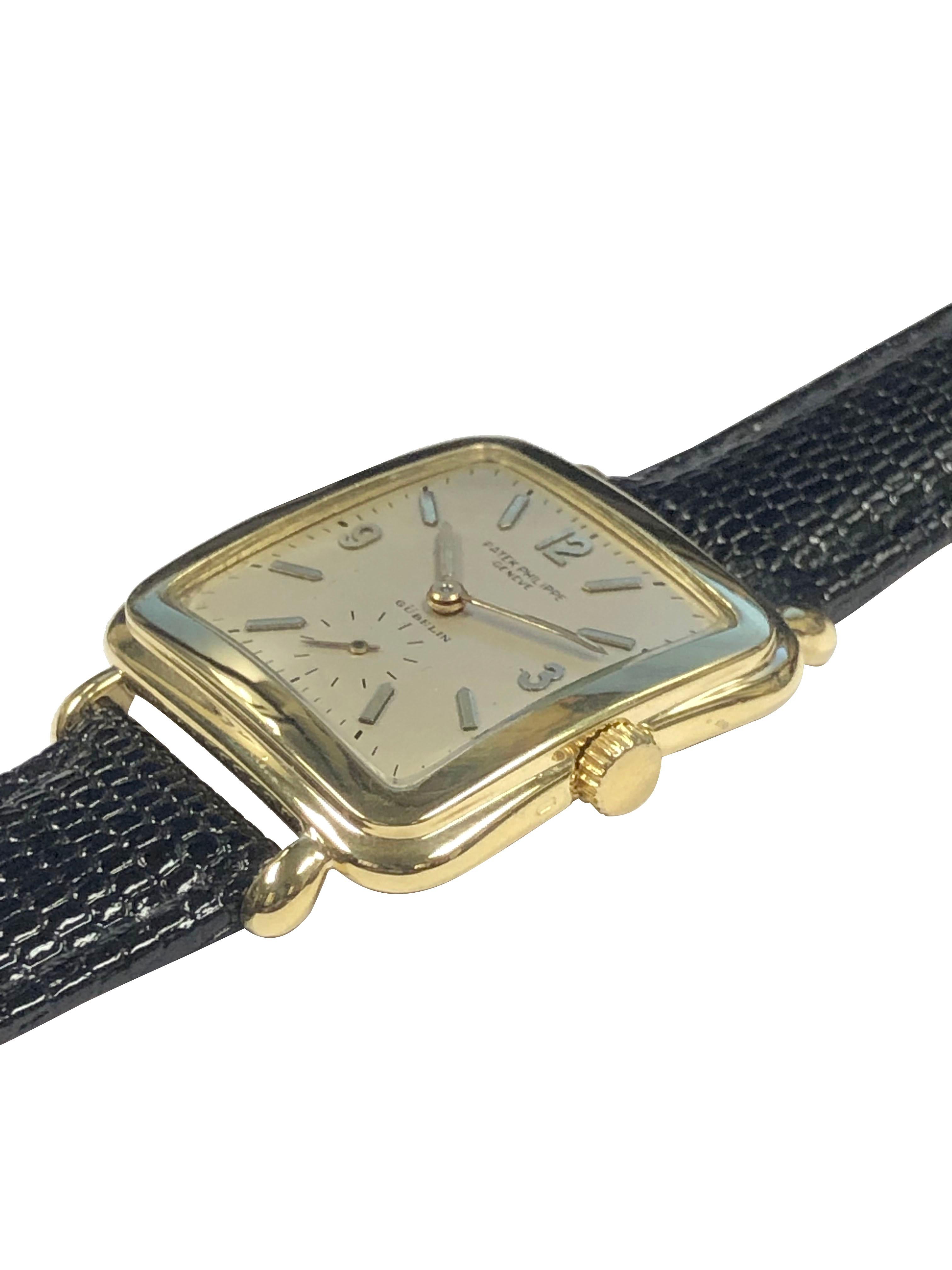 Circa 1950s Patek Philippe Reference 2493 Wrist Watch, 30 x 30 MM 18k Yellow Gold 2 piece stepped, cushion case with tear Drop lugs. Caliber 10-200 18 Jewel Nickle Lever movement. Silver Satin dial with raised Gold markers and printed with Gubelin