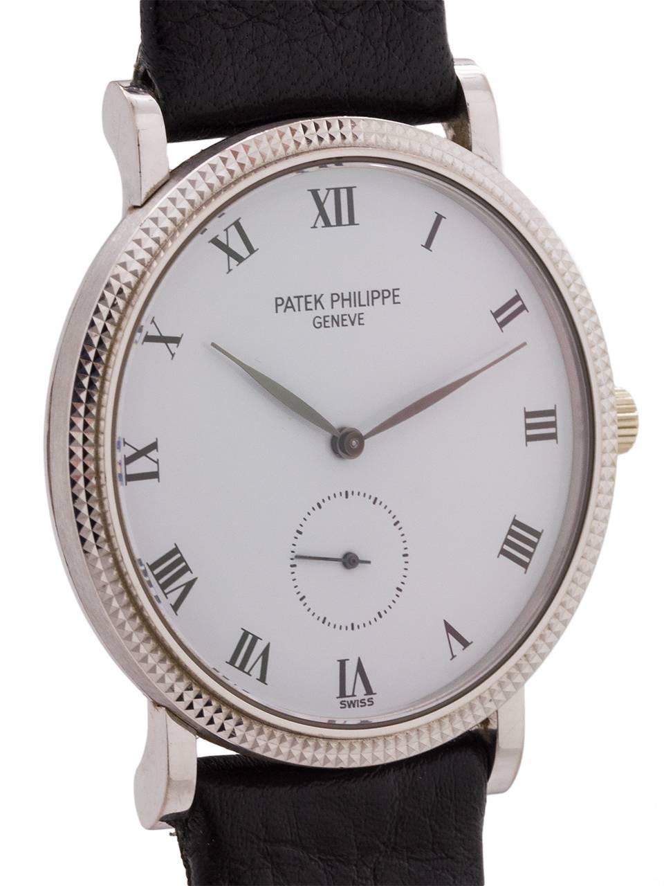 
Patek Philippe 18K WG Hobnail bezel Calatrava ref 3919 circa 1990’s. Classic  design featuring hobnail bezel 33mm diameter case model with heavy snap on back. With pristine condition snow white dial with bold printedRoman indexes and tapered blued