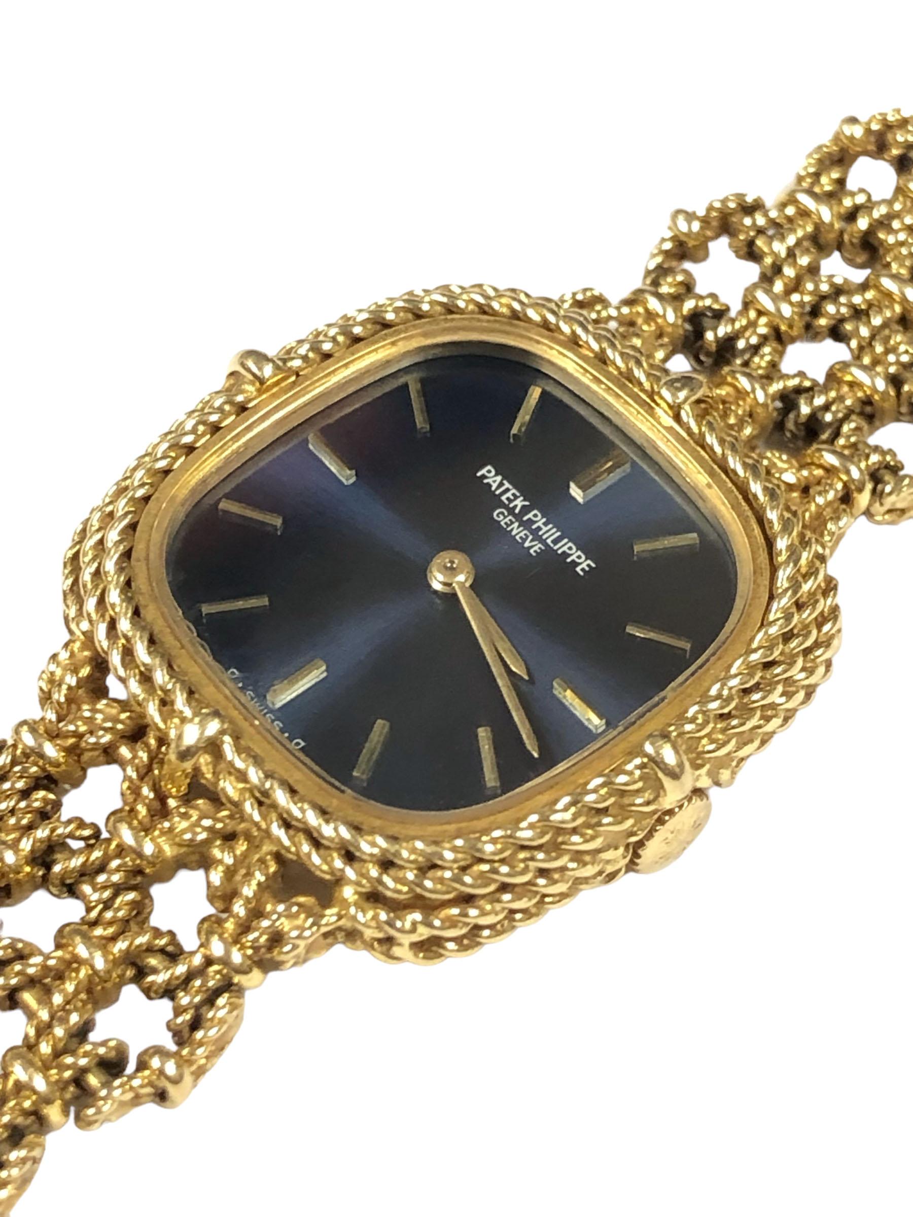 Circa 1970s Patek Philippe Reference 4265 Ladies wrist watch, 23 x 22 M.M 18k Yellow Gold Cushion shape 2 piece case with twisted Rope style case and bezel. 18 Jewel Mechanical, manual wind, Nickle Lever movement, Patek Philippe Logo Crown. Blue