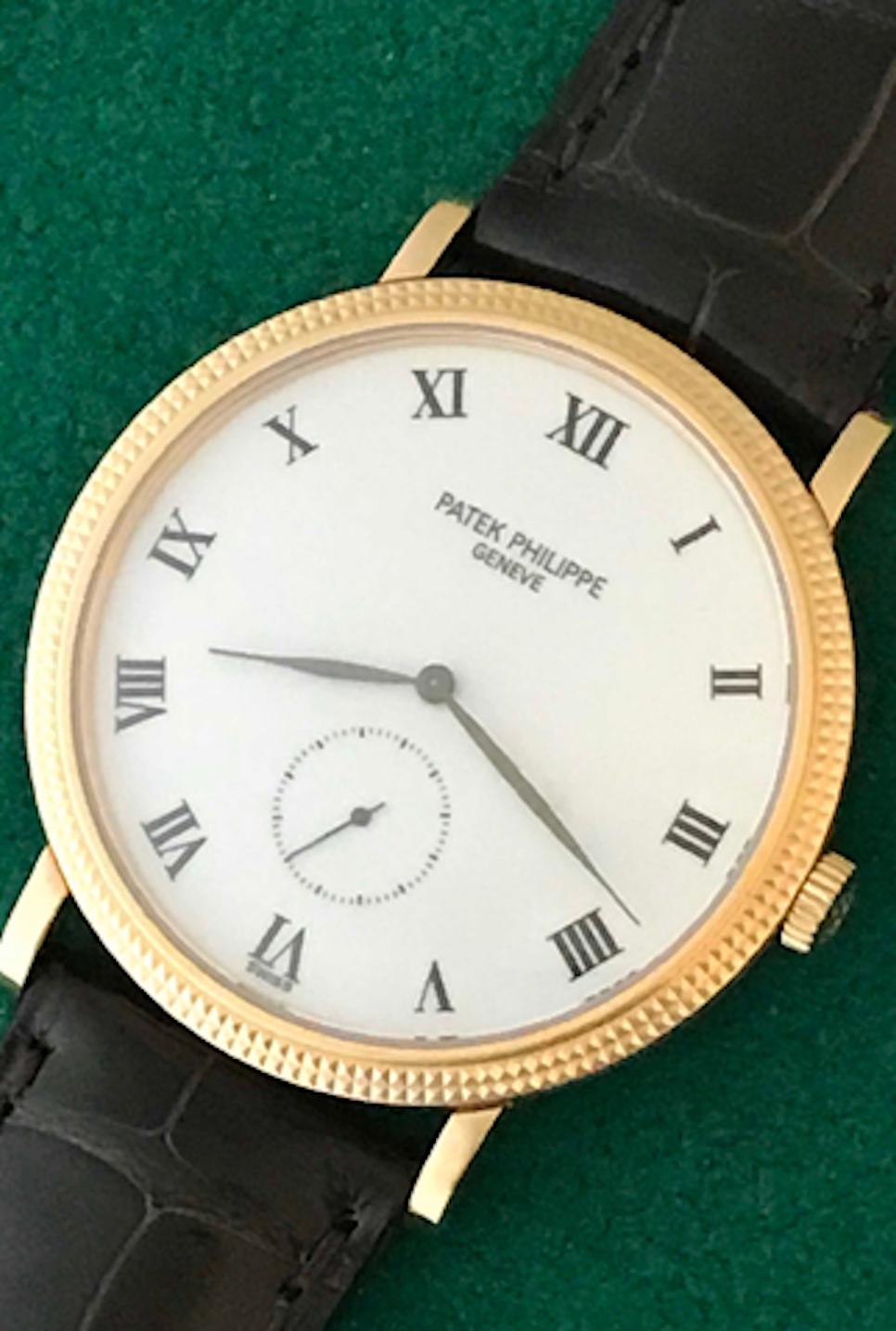 The Patek Philippe Calatrava Ref 3919R Certified pre-owned men's wrist watch. Features the Patek Philippe Caliber 215 with eighteen (18) jewels and classic white dial with black Roman numerals. 18k Rose Gold Patek Philippe case with hobnail bezel.