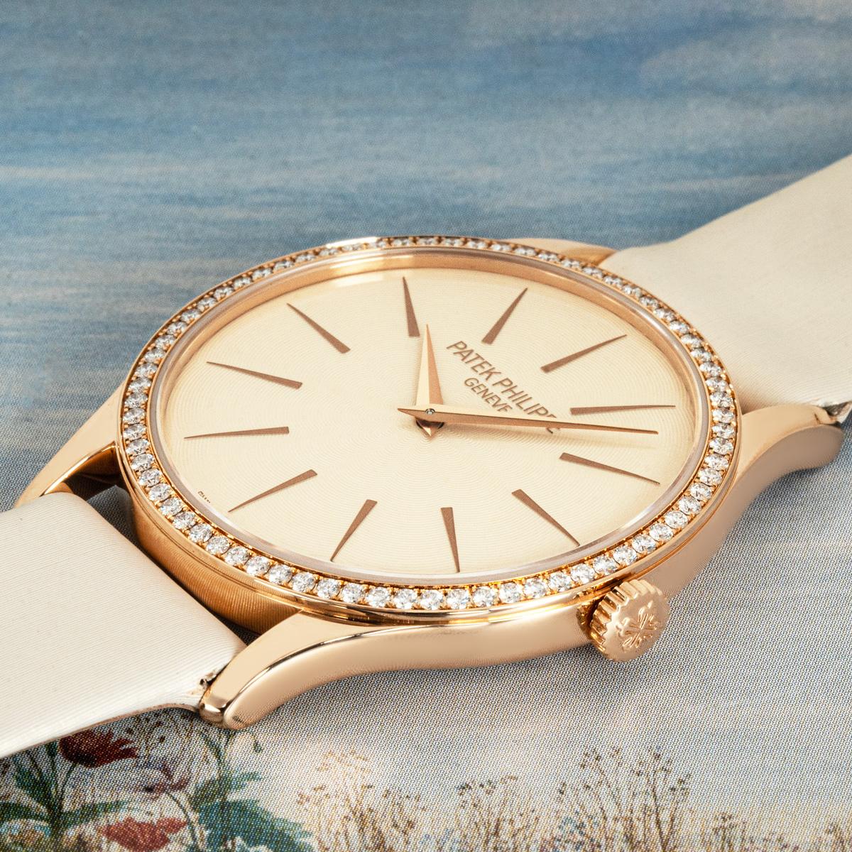 A ladies Calatrava in rose gold by Patek Philippe. Featuring a cream dial with a rose gold bezel set with 72 round brilliant diamonds, weighing 0.52ct.

Fitted with sapphire crystal and a manual wind movement which can be admired through the
