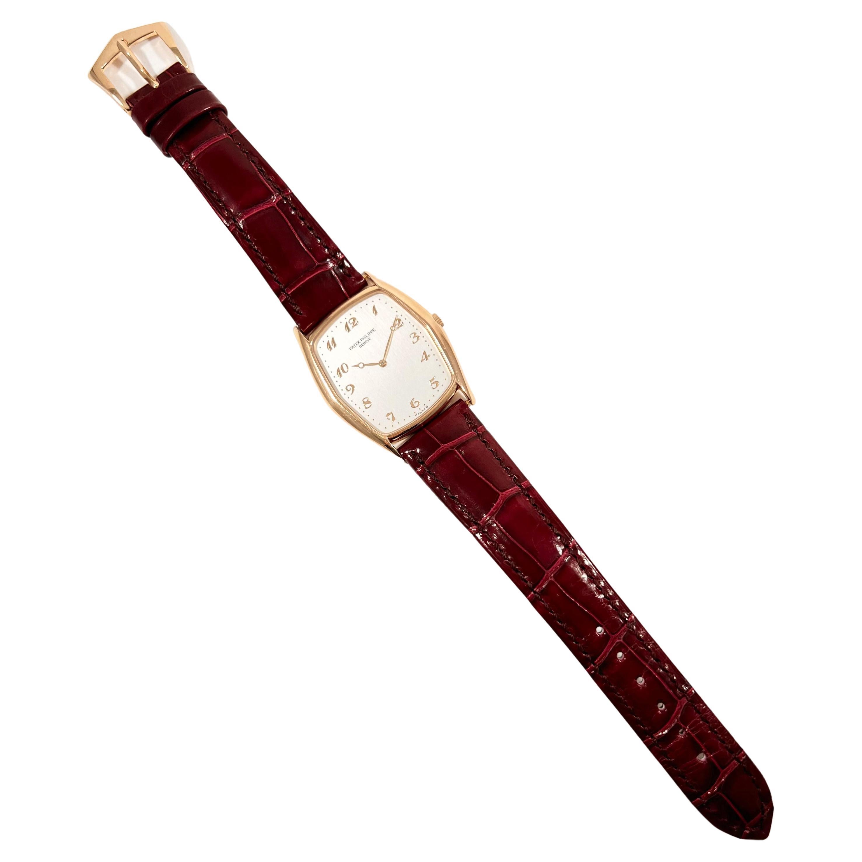 Pre-owned Patek Philippe Gondolo wristwatch (ref. 3842R), featuring a manual-winding movement; silvered dial with applied Arabic numerals; and 29mm, 18k rose gold case on a burgundy-red alligator strap secured by the Patek 18k rose gold ardillon