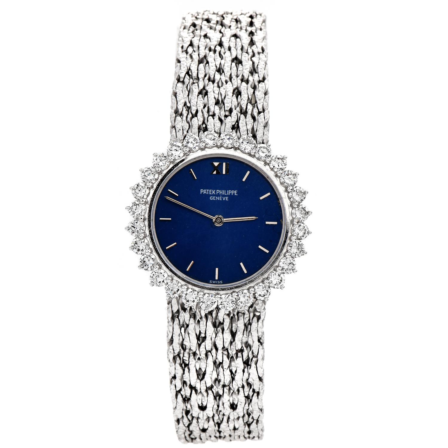 This exquisite all-original Patek Philippe ladies' watch is crafted in 18k white gold. The case presents an attractive royal blue dial embraced by 29 Factory set round brilliant cut diamonds approx. 1.70cttw, F-G color, VVS clarity. The band exposes