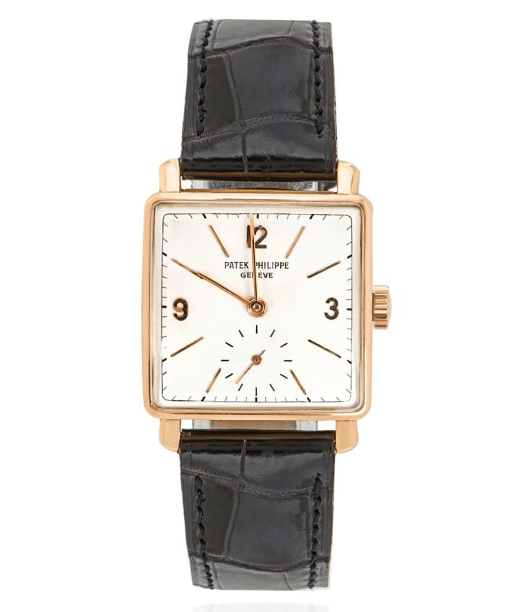 A 26mm Square wristwatch crafted in rose gold by Patek Philippe. Features a white dial with applied arabic numerlas 12,3,9, a small seconds subdial and a fixed rose gold bezel. Fitted with a plastic glass, a manual winding movement and a black Patek