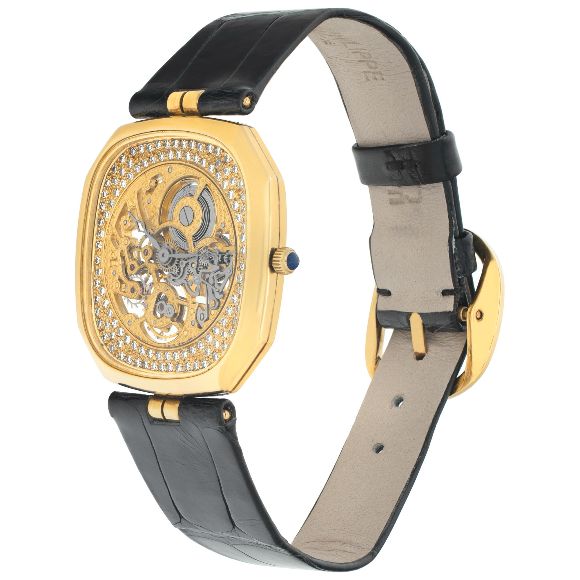 Patek Philippe Squelette skeleton octogonal watch in 18k with pave diamond dial. Manual watch on glossy black alligator strap & original 18k yellow gold Patek Philippe tang buckle. 30 mm case size. Ref 3887. Arcchive papers. Fine Pre-owned Patek