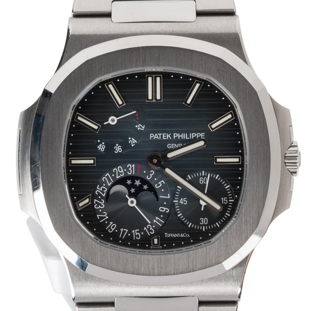 Guaranteed authentic Patek Phillippe extremely rare Tiffany&Co co-brand Nautilus 5712/1A men's steel watch.
Anthracite dial features horizontal textured stripes.
Applied luminous steel faceted baton hands and luminous outer dot minute divisions.
At