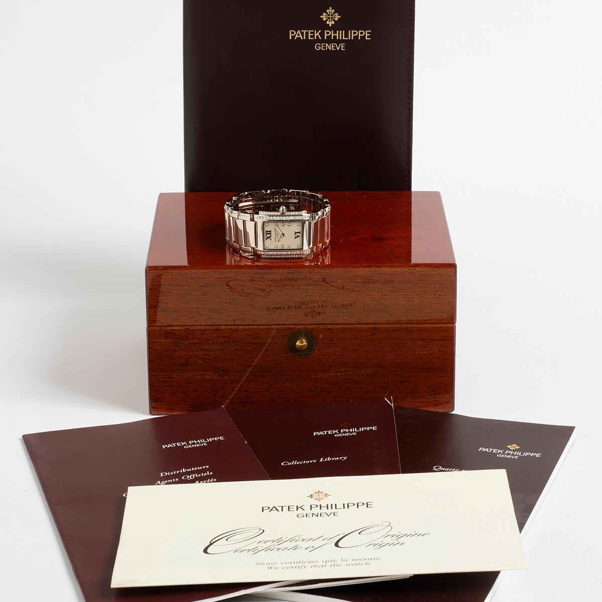 Our classic ladies Patek Philippe Twenty-4 (twenty four) reference 4910/20G features a 18k white gold case of 25mm by 30mm (lug to lug) and 18k white gold bracelet. Featuring a factory set diamond opaline dial (ten diamonds) and two row bezel (32