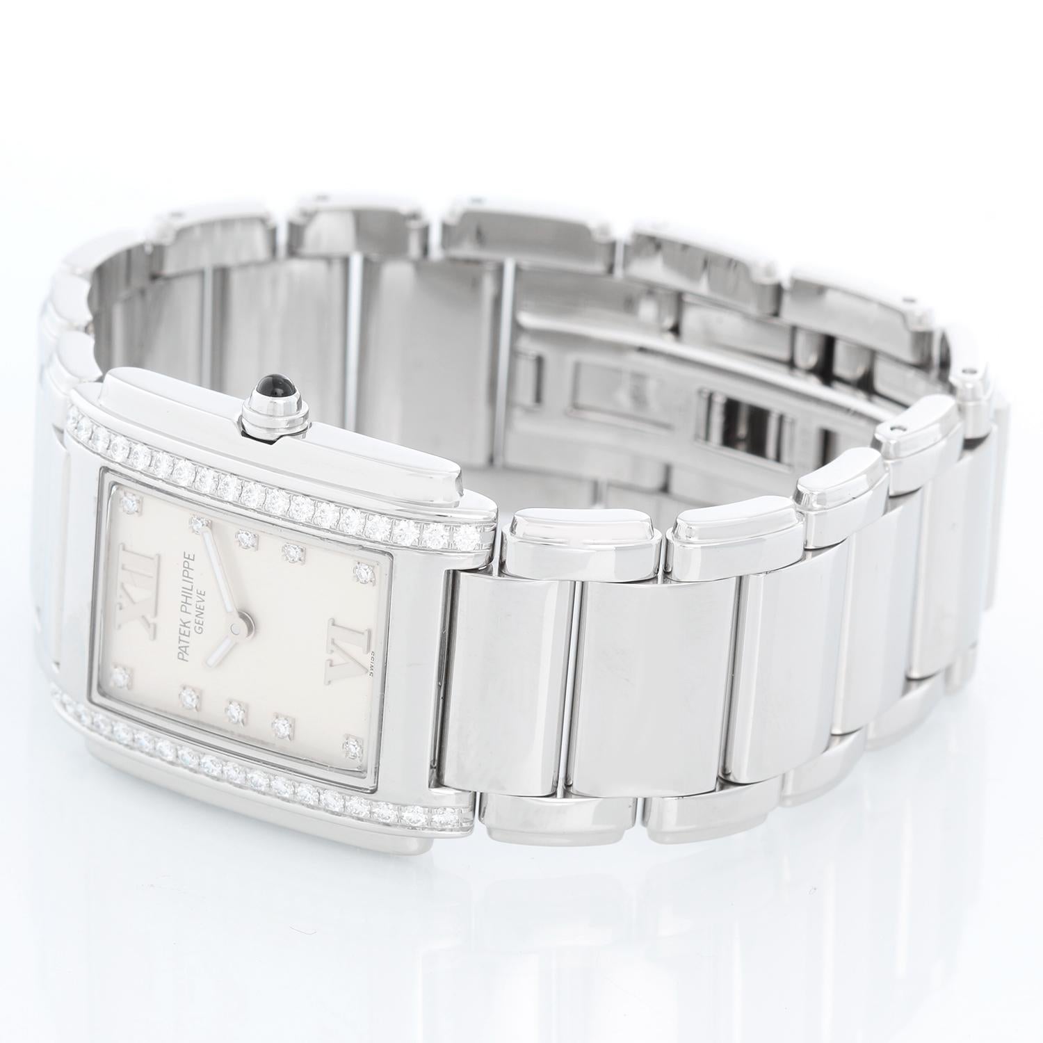 Patek Philippe Twenty-4 Ladies Steel & Diamond Watch 4910/10 - Quartz. Stainless steel set with 36 diamonds. Silver/white dial with diamond markers and Roman numerals. Stainless steel Patek Philippe bracelet with deployant clasp. Pre-owned with