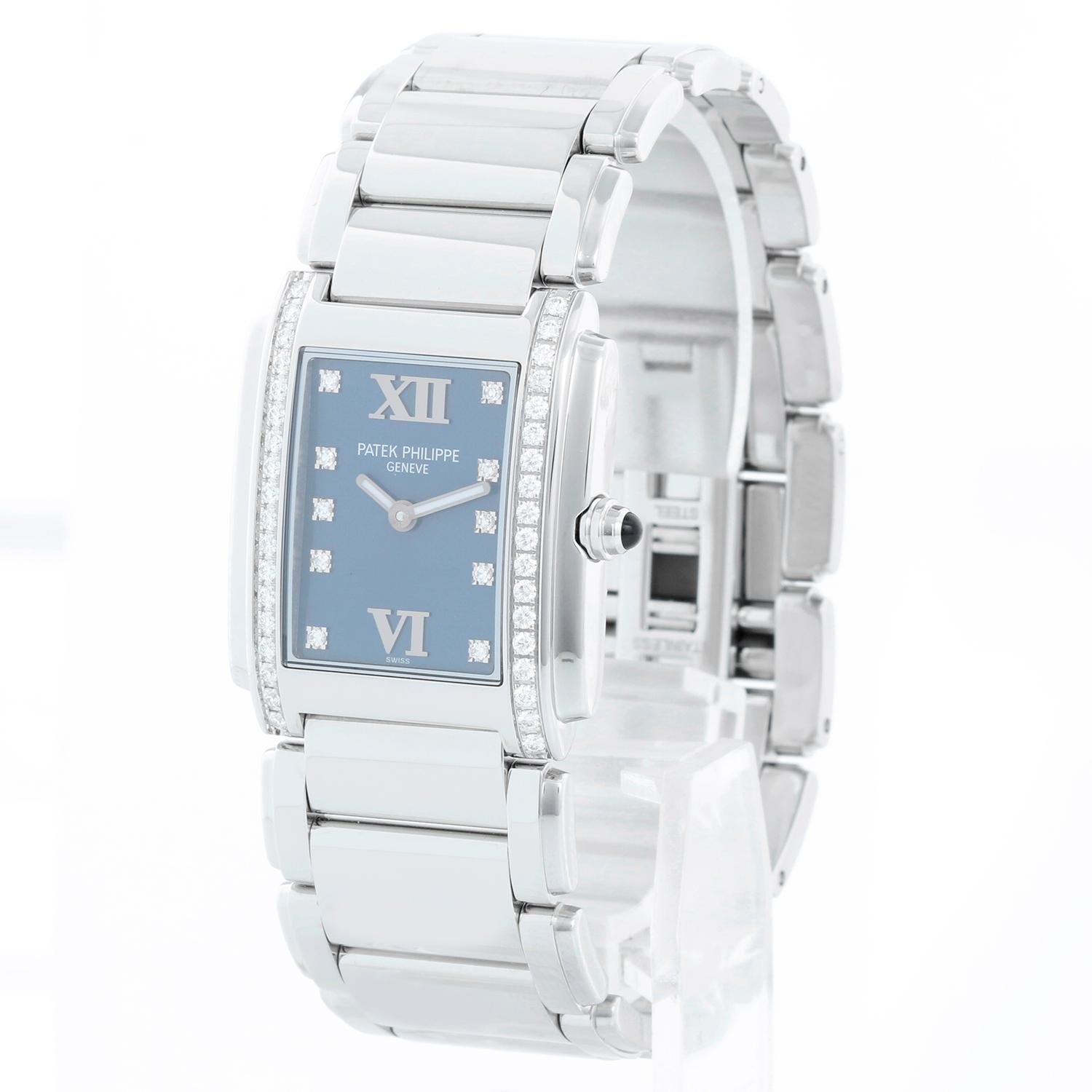 Patek Philippe Twenty-4 Ladies Steel & Diamond Watch 4910/10A - Quartz. Stainless steel case; bezel set with 36 diamonds (25mm x 30mm). Blue dial with diamond markers and Roman numerals. Stainless steel Patek Philippe bracelet. Pre-owned with Patek