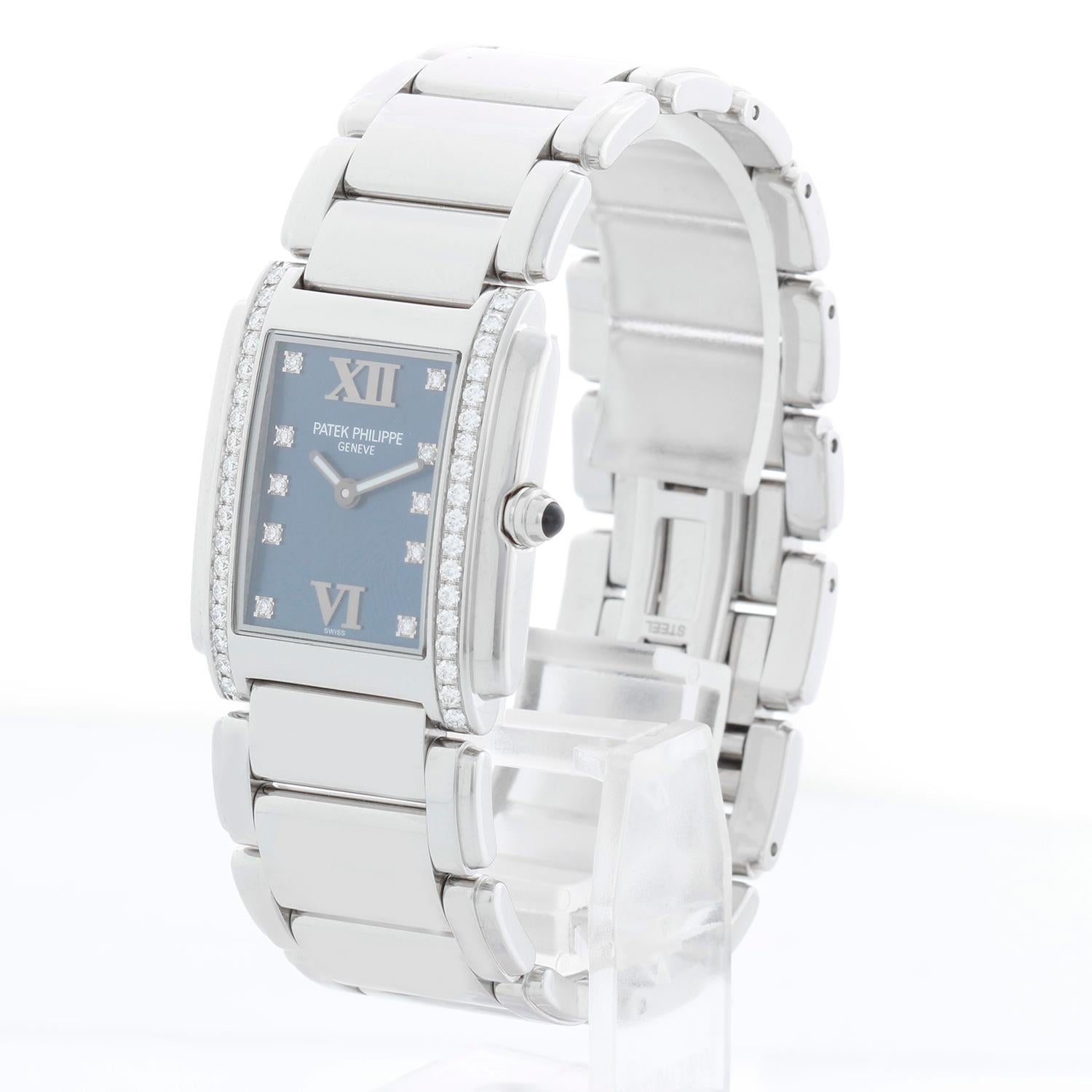 Patek Philippe Twenty-4 Ladies Steel & Diamond Watch 4910/10A - Quartz. Stainless steel case; bezel set with 36 diamonds (25mm x 30mm). Blue dial with diamond markers and Roman numerals. Stainless steel Patek Philippe bracelet. Pre-owned with Patek