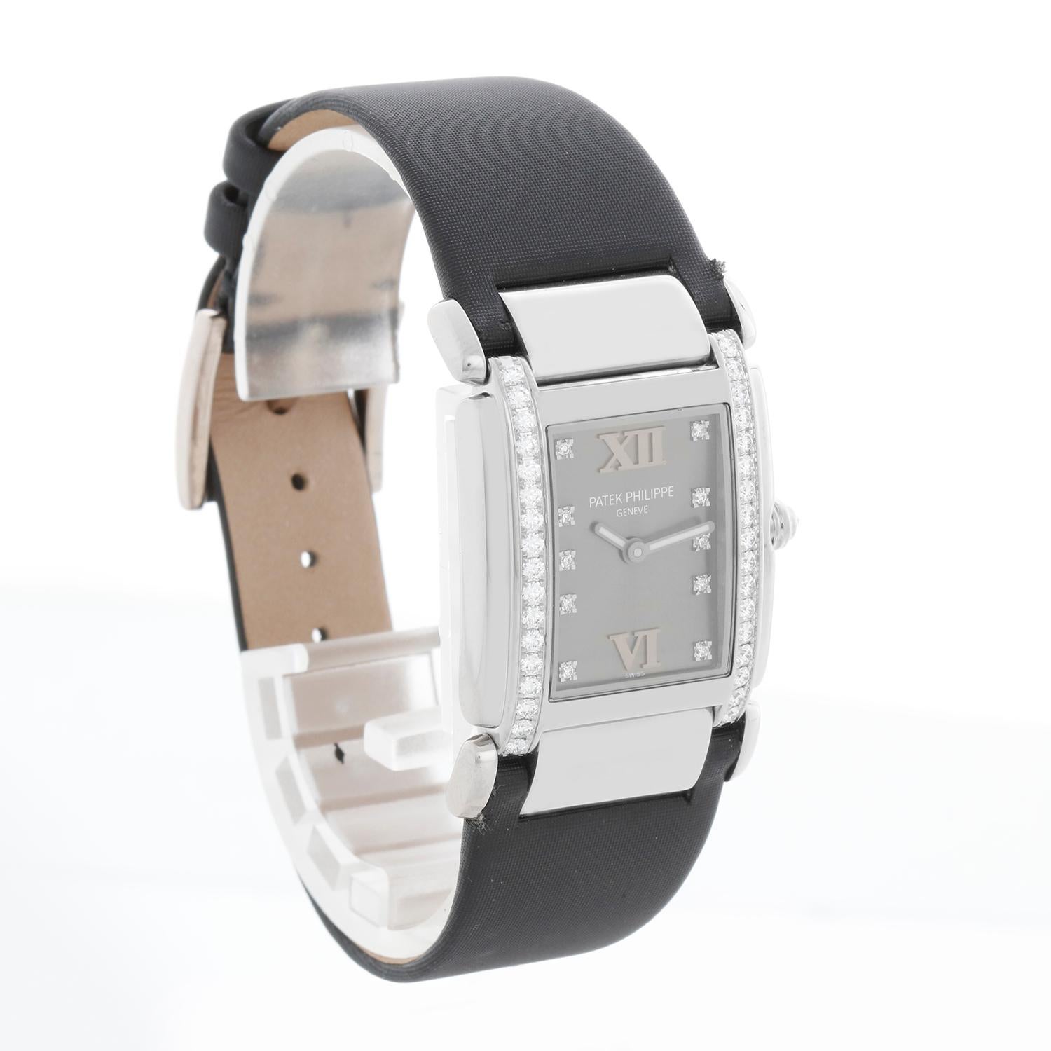 Patek Philippe Twenty-4 White Gold Diamond Ladies Watch 4920G (4920) - Quartz. Twenty-4. 18k white gold case with diamond bezel (25mm x 30mm). Grey dial with diamond hour markers and Roman numeral 12 
6. Black satin Patek Philippe band and 18k