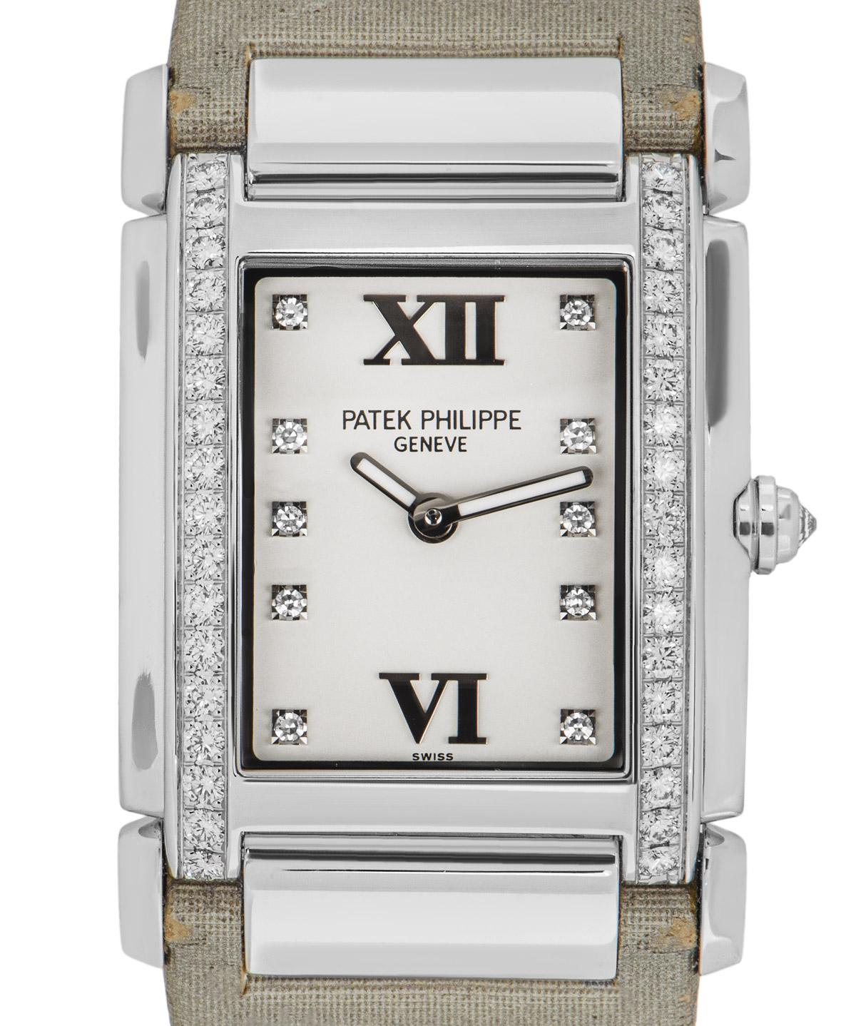 A ladies Twenty~4 wristwatch by Patek Philippe. Featuring an opaline silvered dial with 10 diamond hour markers and roman numerals VI and XII. The bezel is set with 34 round brilliant cut diamonds and the crown set with a single inverted diamond
