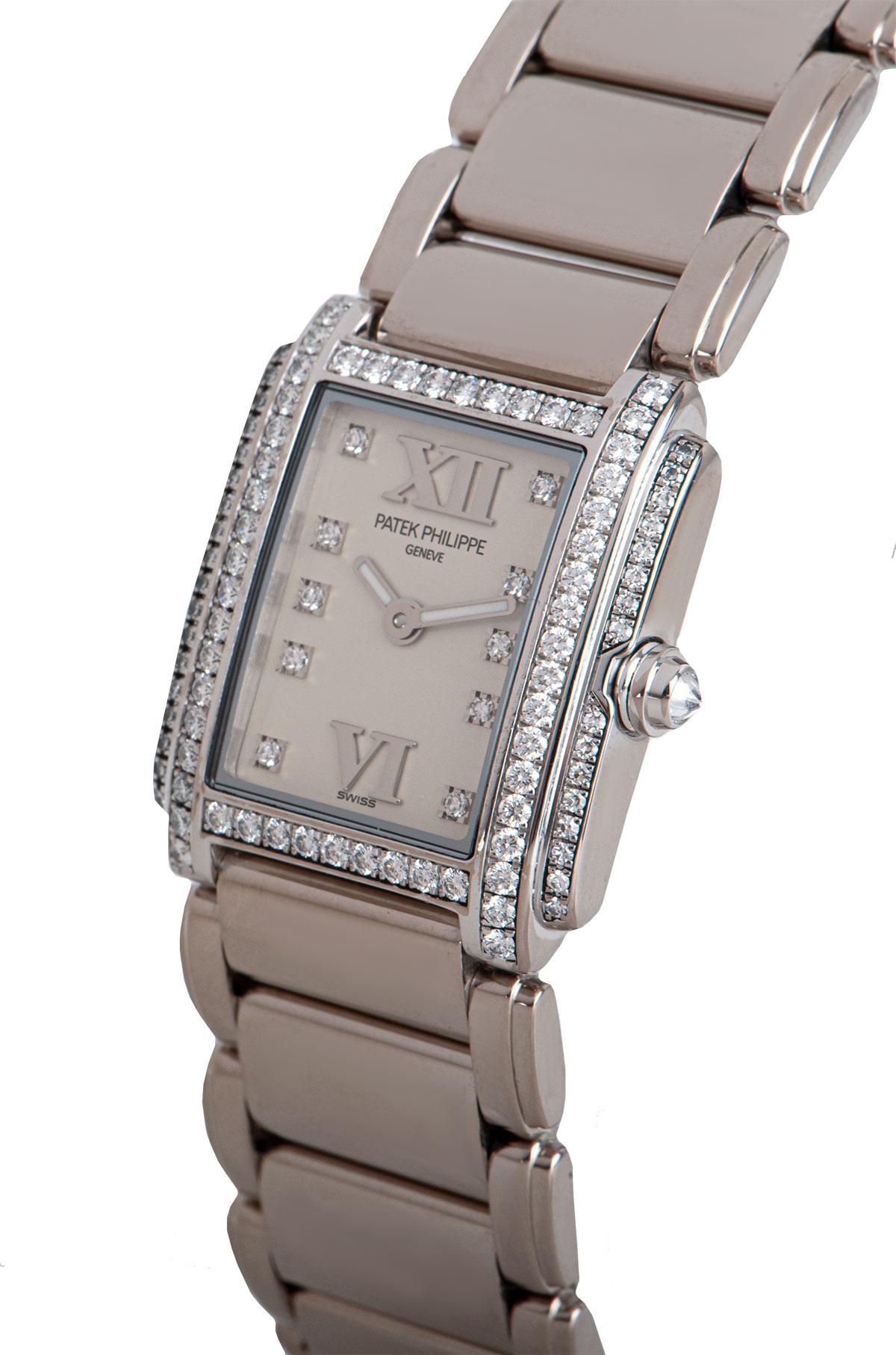 A 22 mm 18k White Gold Twenty-4 Ladies Wristwatch, timeless white dial set with 10 applied round brilliant cut diamond hour markers, applied roman numerals VI and XII, a fixed 18k white gold bezel set with 54 round brilliant cut diamonds, an 18k