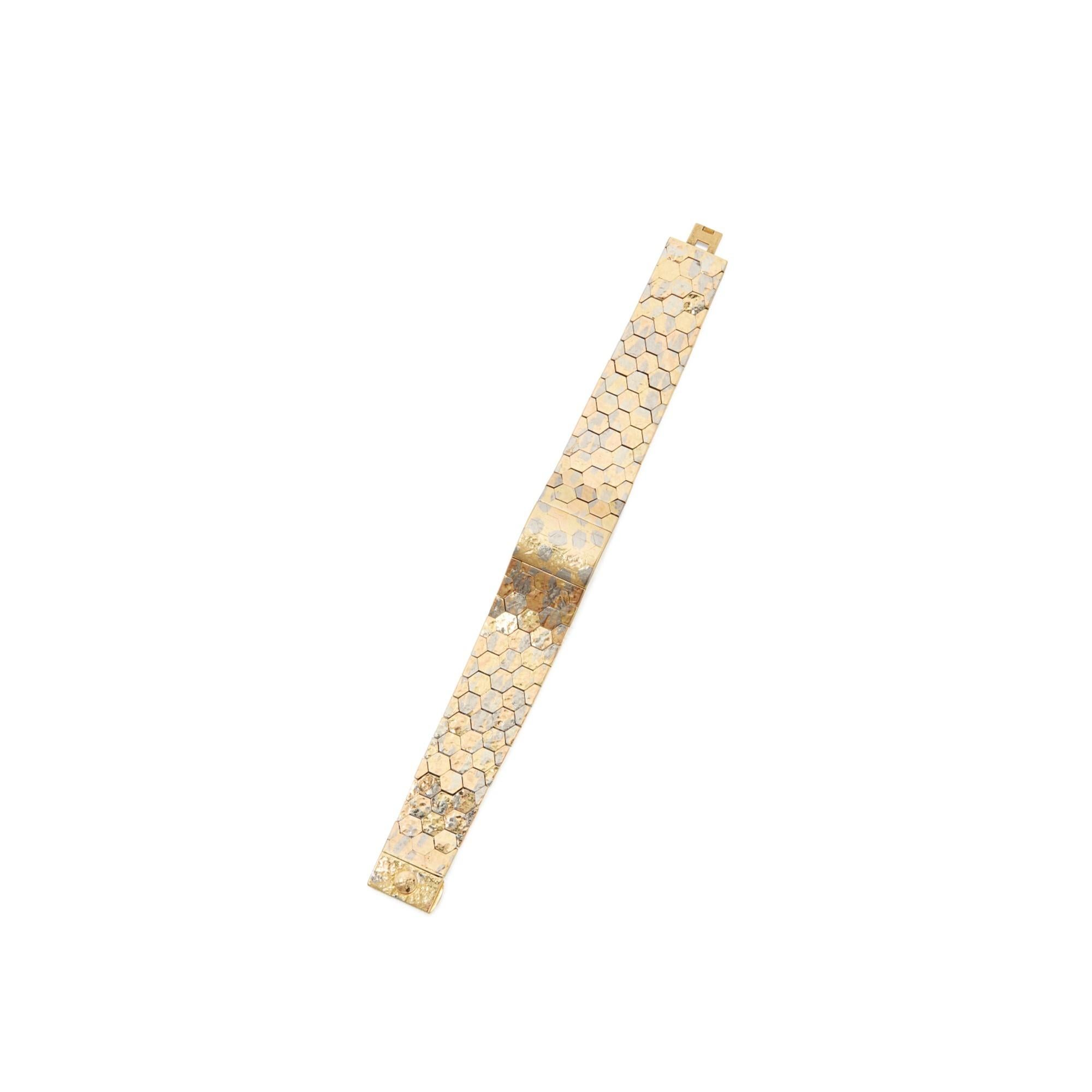 Two-Color Gold Lady's Wristwatch by Patek Philippe
The bracelet composed of textured white and yellow gold hexagonal links, concealing a round dial featuring gold baton indicators, manual movement, gross weight approximately 54 dwts, length 6¾