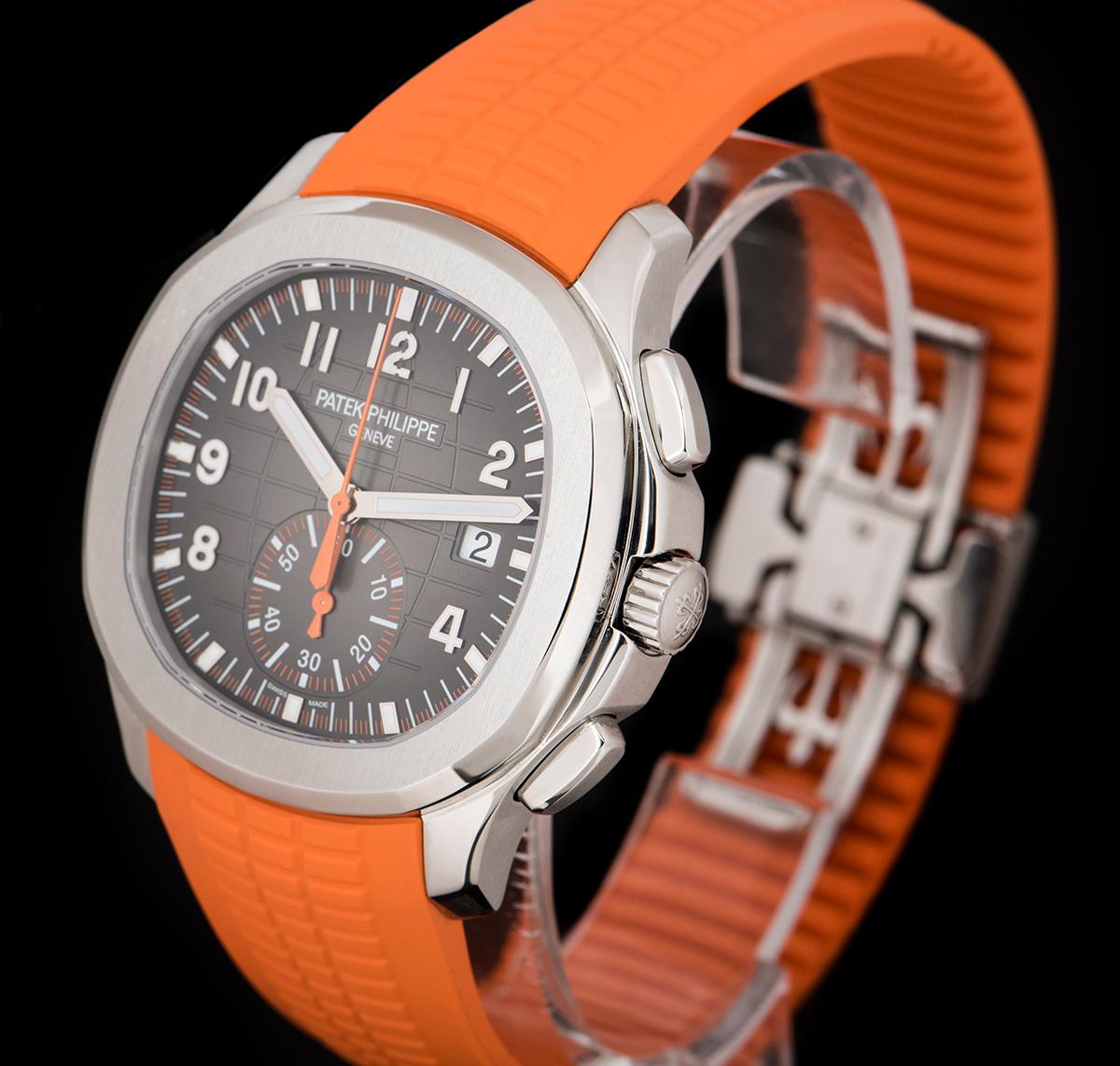 An Unworn Stainless Steel Aquanaut Gents Wristwatch, black embossed dial with applied arabic numbers, date at 3 0'clock, 60 minute recorder at 6 0'clock, orange chronograph hand, a fixed stainless steel bezel, an original orange  