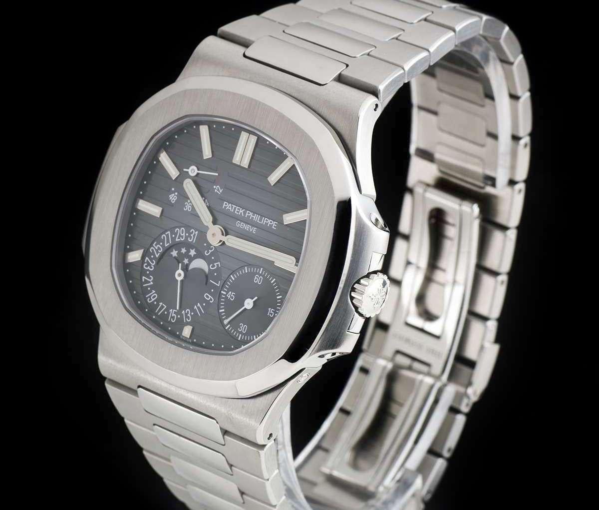 An Unworn Stainless Steel Nautilus Gents Wristwatch, black-blue dial with applied hour markers, small seconds at 4 0'clock, date and moonphase indicator at 7 0'clock, 48 hour power reserve indicator between 10 and 11 0'clock, a fixed stainless steel