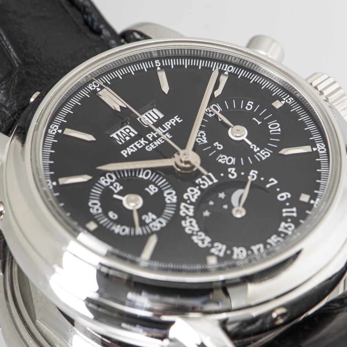 A very rare Grand Complications 36mm Perpetual Calendar Chronograph in platinum by Patek Philippe. Its black dial features displays of the moon phase, the date, day, month and leap year as well as featuring the three chronograph counters. To find