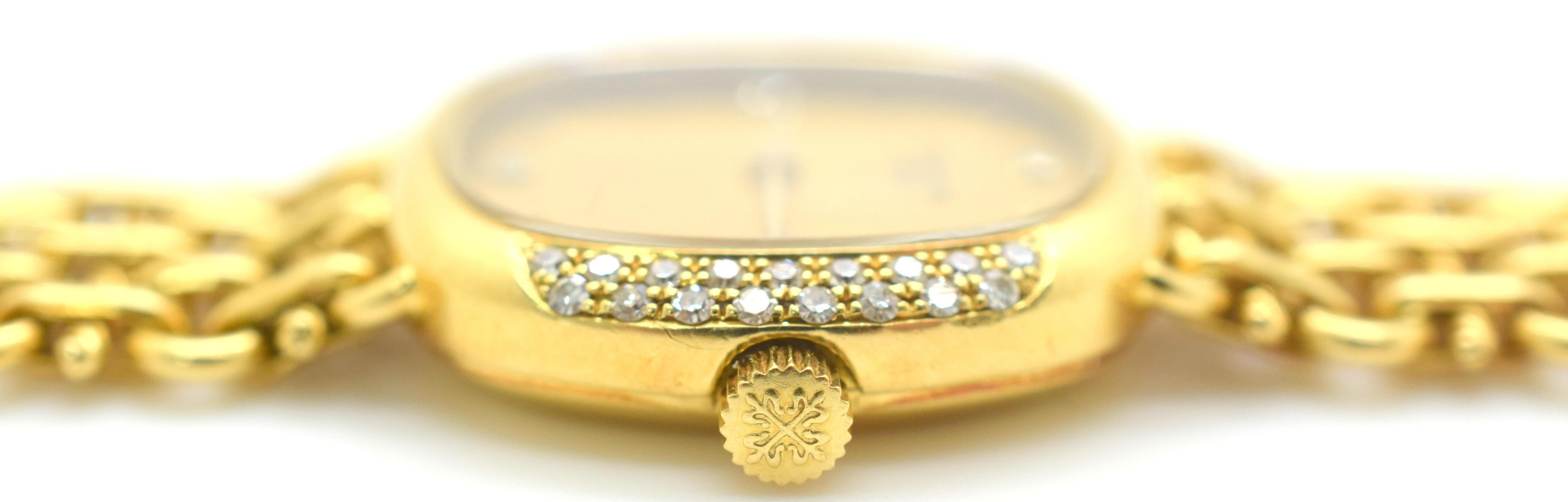 Vintage Patek Philippe diamond 18K gold ladies wrist watch, circa 1980. This 6-7/8 inch Swiss wrist watch has a diamond accented 18 karat yellow gold case with mesh bracelet. The Patek Philippe wrist watch features the original golden champagne dial