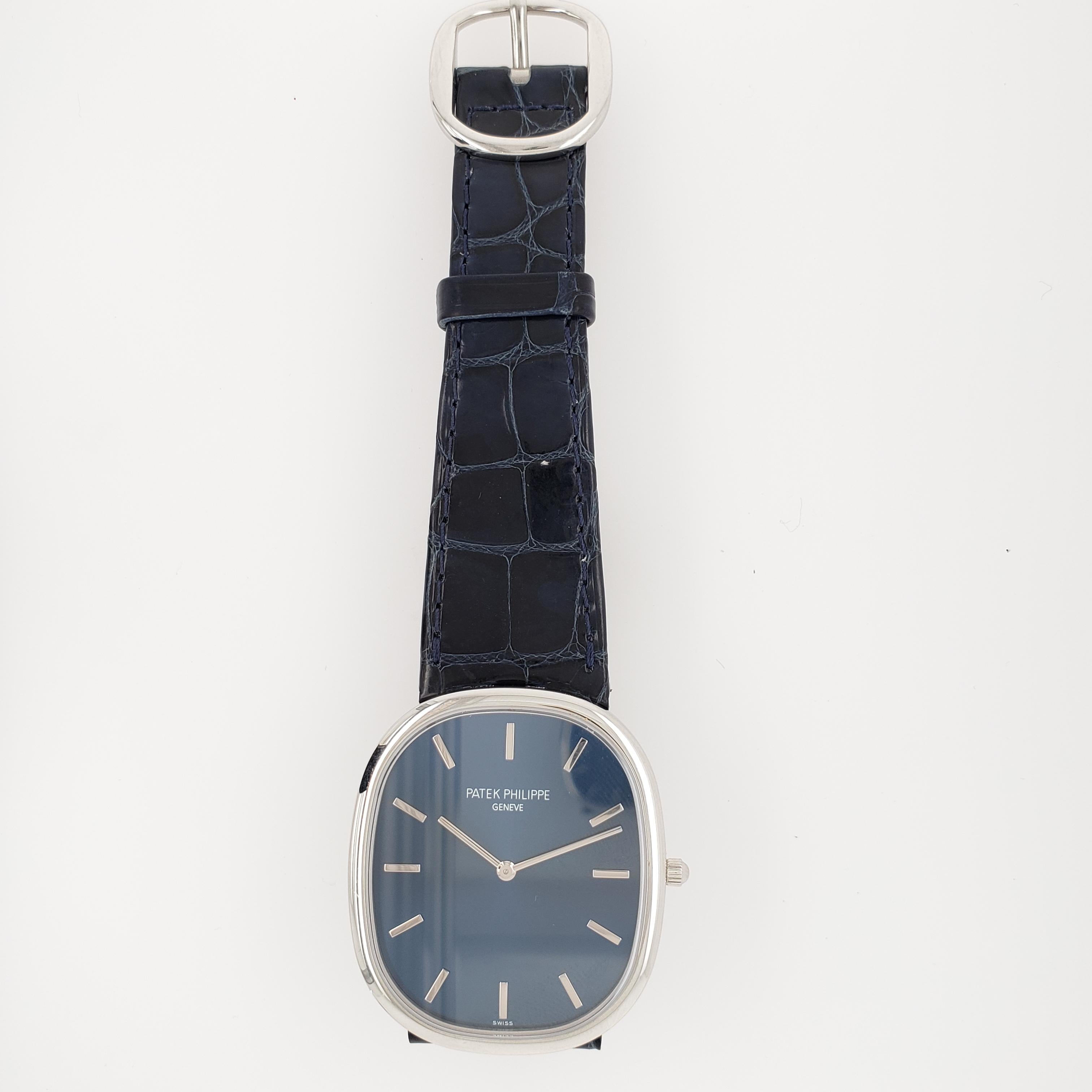 Vintage Patek Philippe Ellipse, model 5738P-001. This watch features a self winding movement with a blue dial, stick markers and a blue leather strap. No box or papers. 