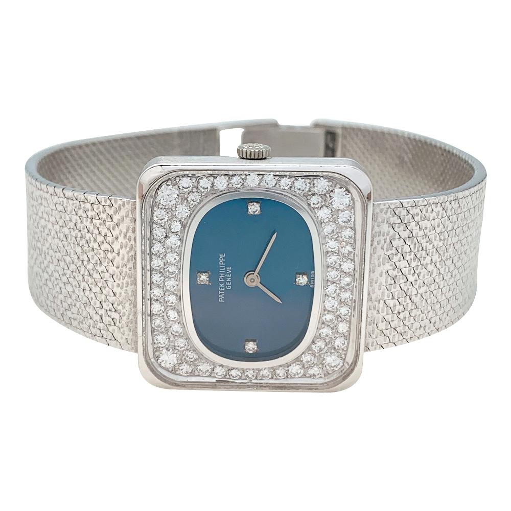 White gold Patek Philippe watch on a white gold bracelet (750/000) with clasp branded.
Square-shaped case, oval-shape blue dial, bezel set with brilliant cut diamonds. 
Manual winding movement cal. 13.5, 20 rubies, Patek Philippe maker mark.
Watch's