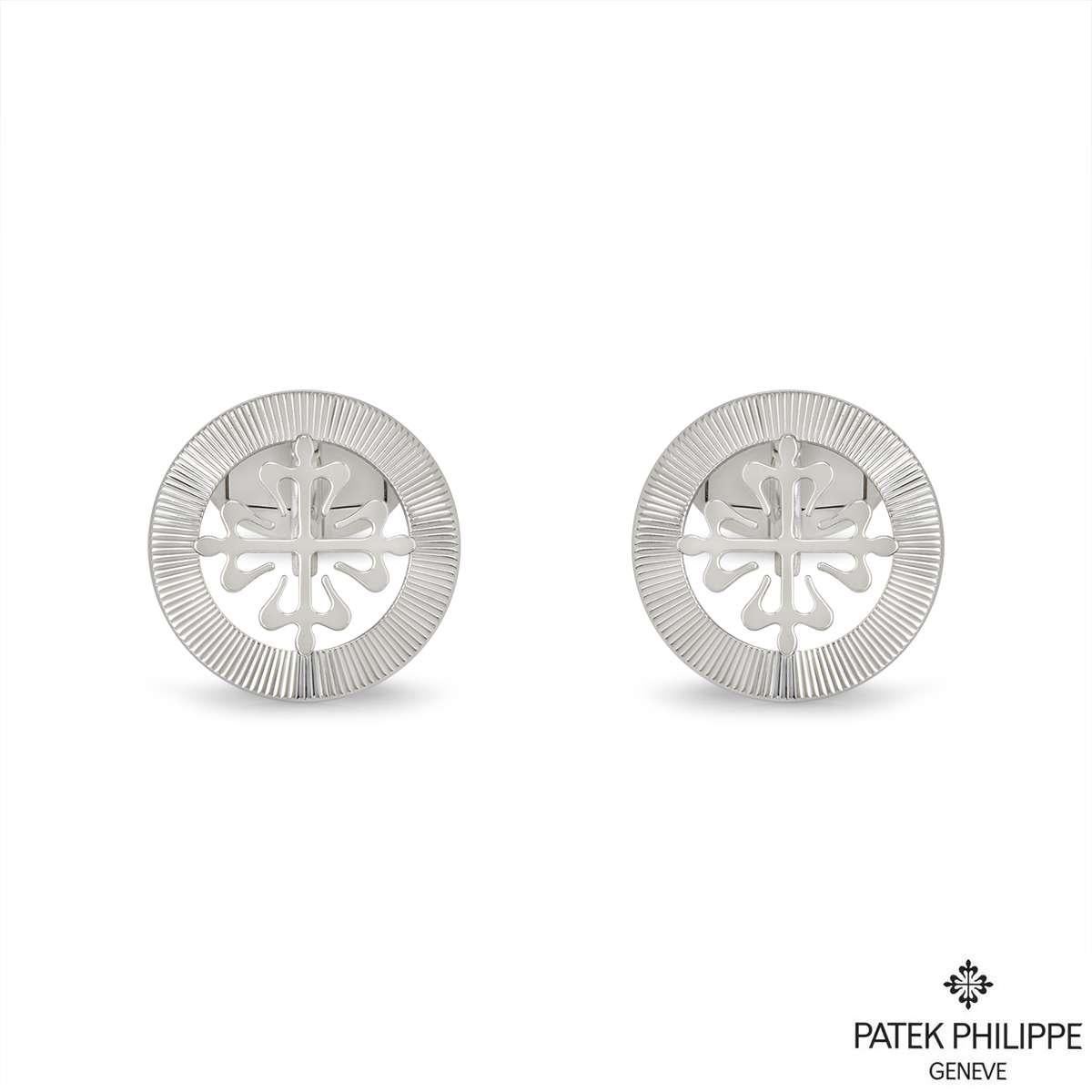 A pair of 18k white gold Calatrava cufflinks by Patek Philippe. The cufflinks feature the classic Calatrava cross motif, surrounded with a guilloche outer edge boarder. The cufflinks have whale back fittings and the motif measures 18mm in diameter.