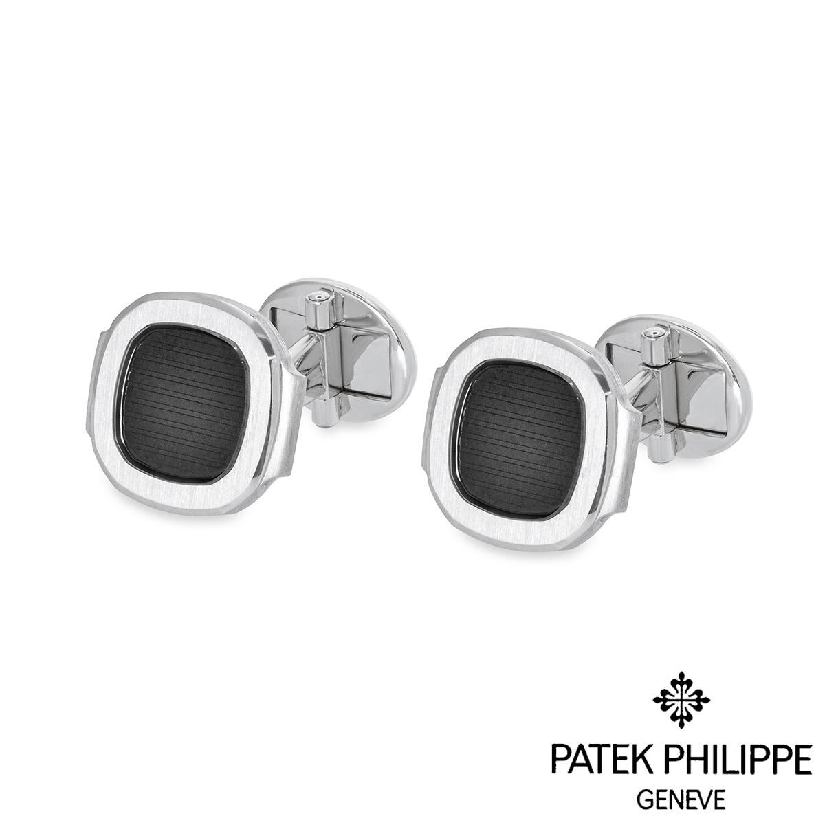A stylish pair of 18k white gold cufflinks by Patek Philippe from the Nautilus collection. The cufflinks are set with the signature black-grey Nautilus panel surrounded by a satin finish border. The cufflinks measure 1.6cm in width, 1.5cm in height,
