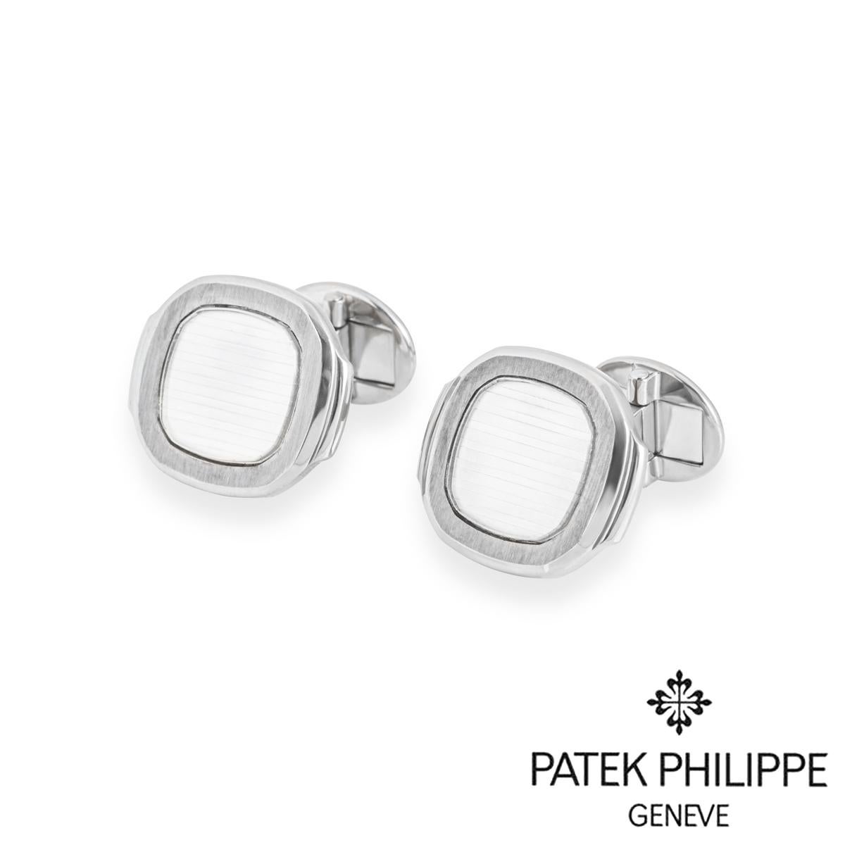 A stylish pair of 18k white gold cufflinks by Patek Philippe from the Nautilus collection. The cufflinks are set with a silvery-white Nautilus panel surrounded by a satin finish border. The cufflinks measure 2.2 cm in length, 1.9 cm in width and