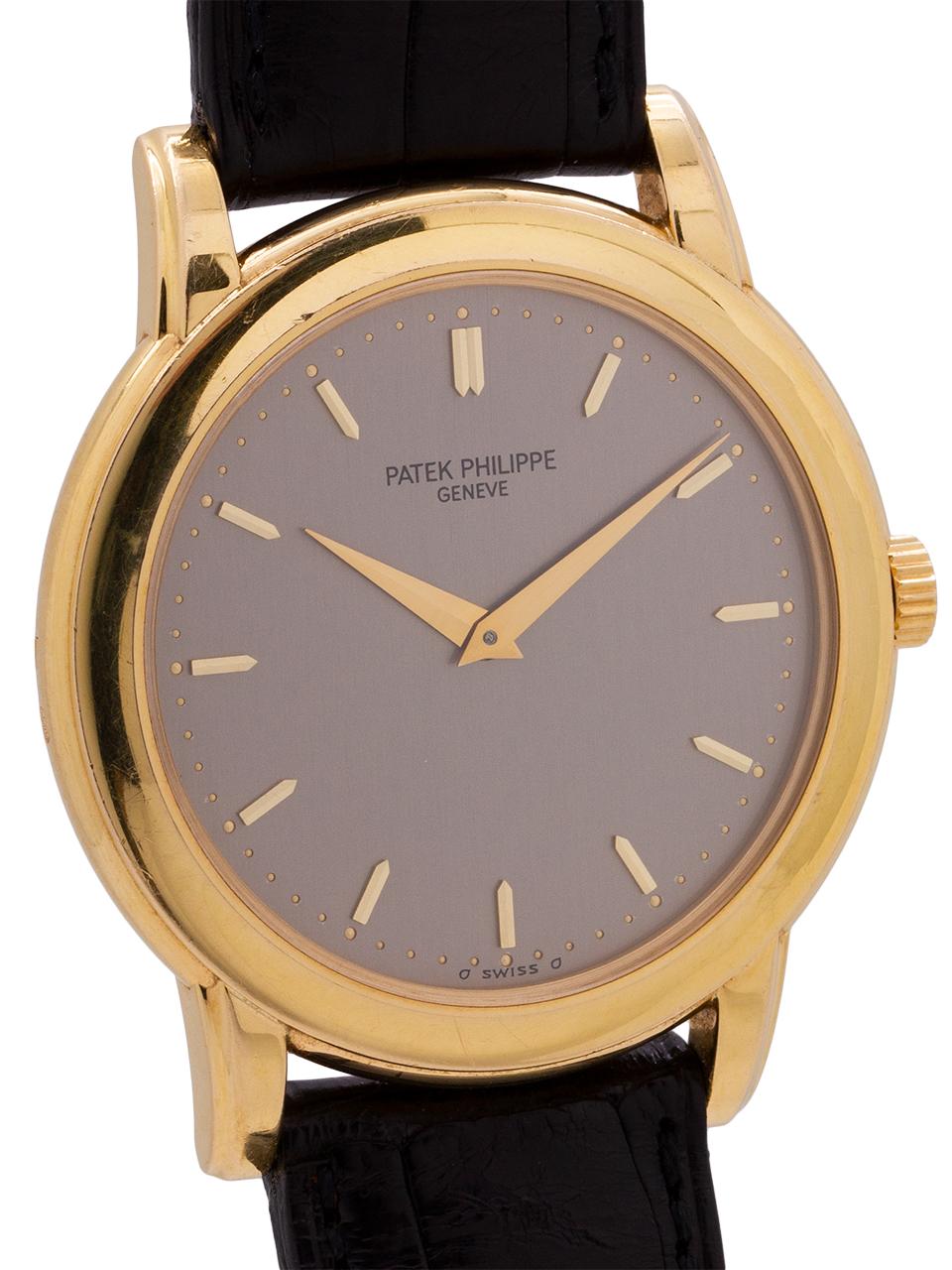 
Patek Philippe 18K yellow gold Calatrava ref 5032 circa 1990’s. Featuring a 36mm diameter case with smooth, stepped bezel and screwdown waterproof caseback. Dark silvered dial with applied gold indexes and gold dauphine hands. Powered by the famous