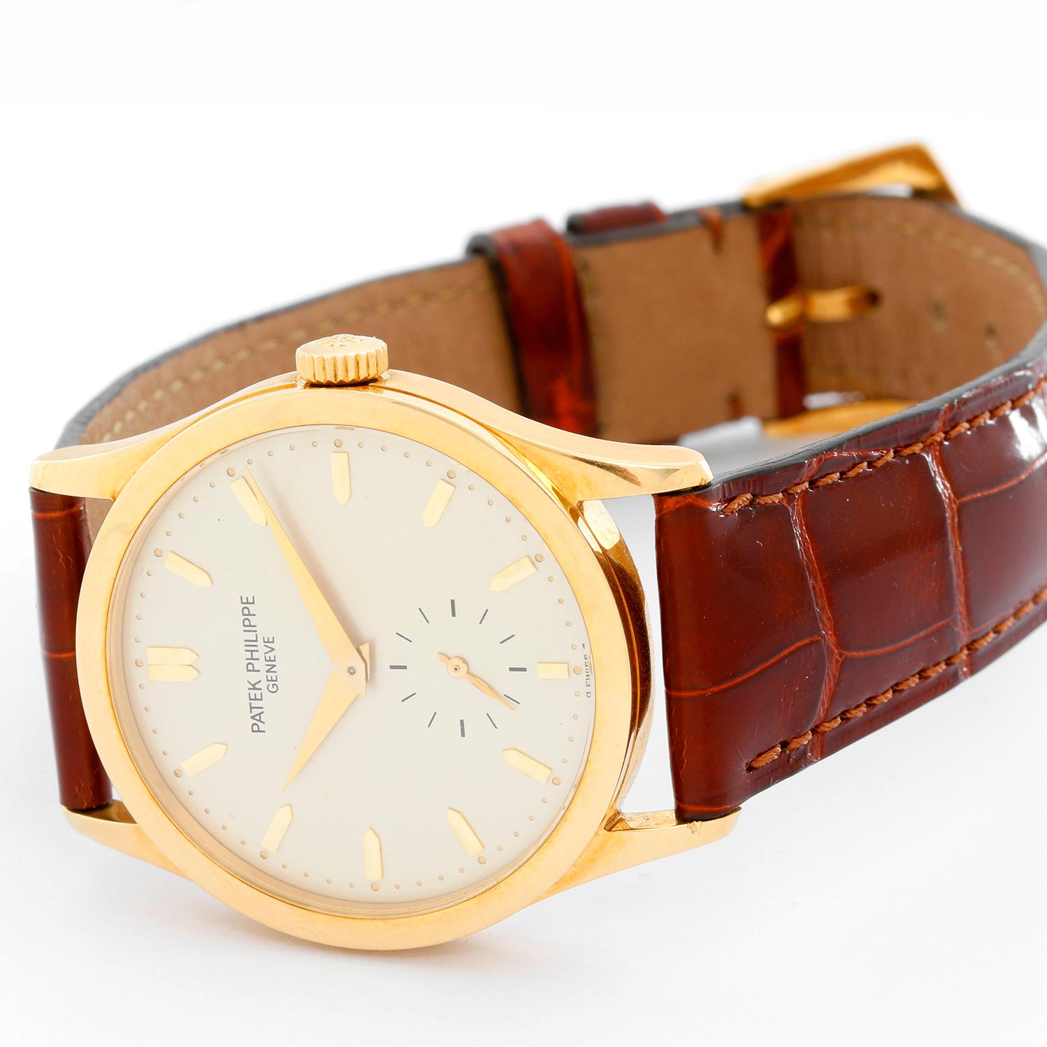 Patek Philippe Yellow Gold Calatrava Men's Watch Ref. 5096 - Manual winding . 18K Yellow gold with a skeleton caseback ( 34 mm ) . Silver dial with raised silver stick hour markers . Brown Patek Philippe & Co. with buckle . Pre-owned with box .f