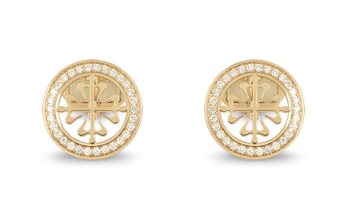 A pair of 18k yellow gold Calatrava cufflinks by Patek Philippe. The cufflinks feature the classic Calatrava cross motif, surrounded with a boarder of round brilliant cut diamonds. There are 60 diamonds in total, with an approximate carat weight of