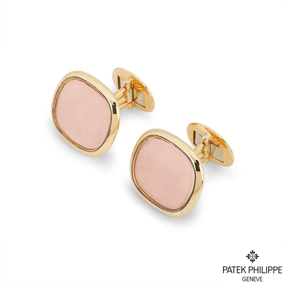 A pair of 18k yellow gold cufflinks by Patek Philippe from the Ellipse collection. The cufflinks are set to the front with a polished yellow gold surround and rose accent enamel center. The cufflinks have whale back fittings and have a gross weight